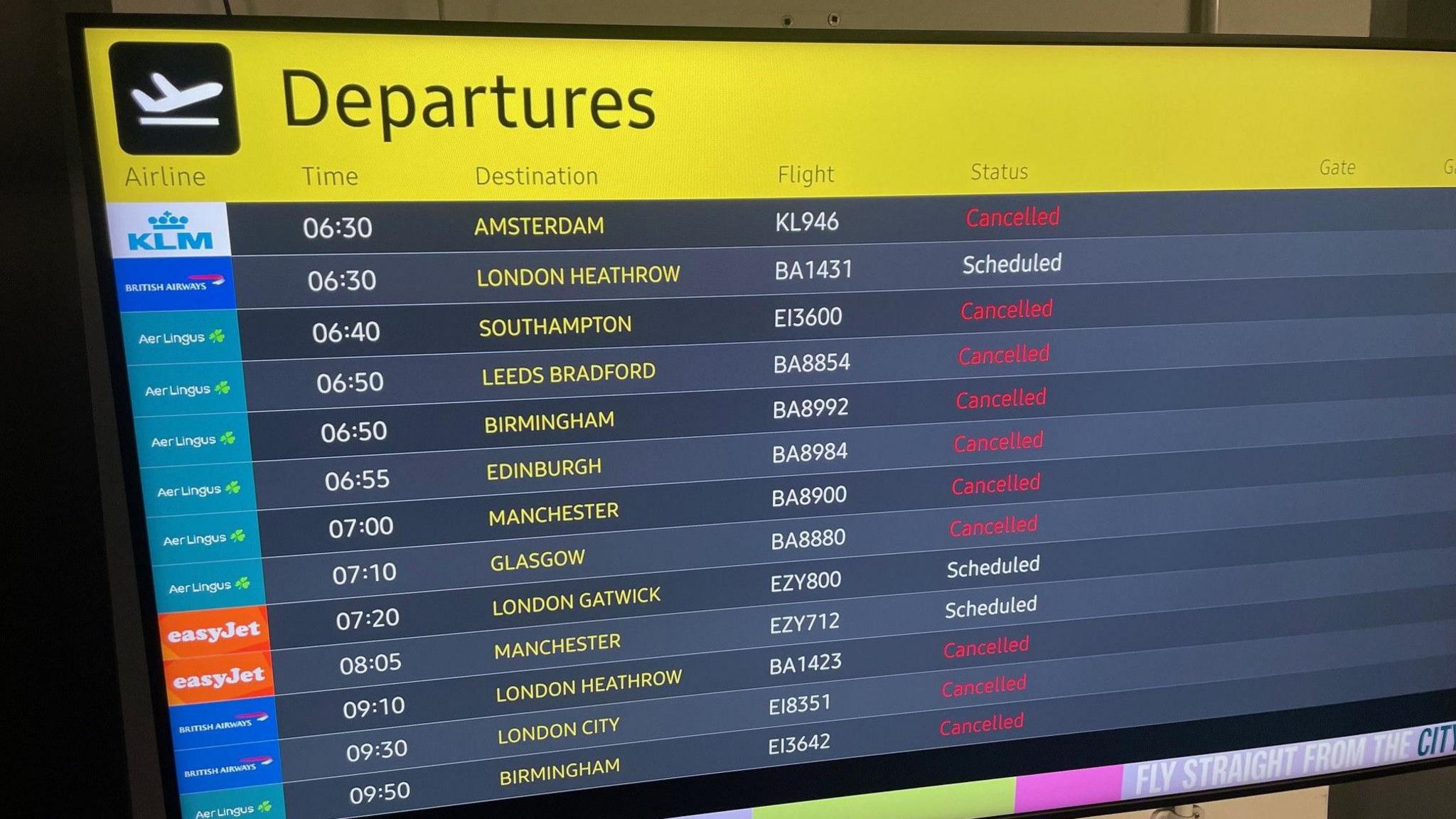 Departure board at Belfast International Airport showing cancelled flights