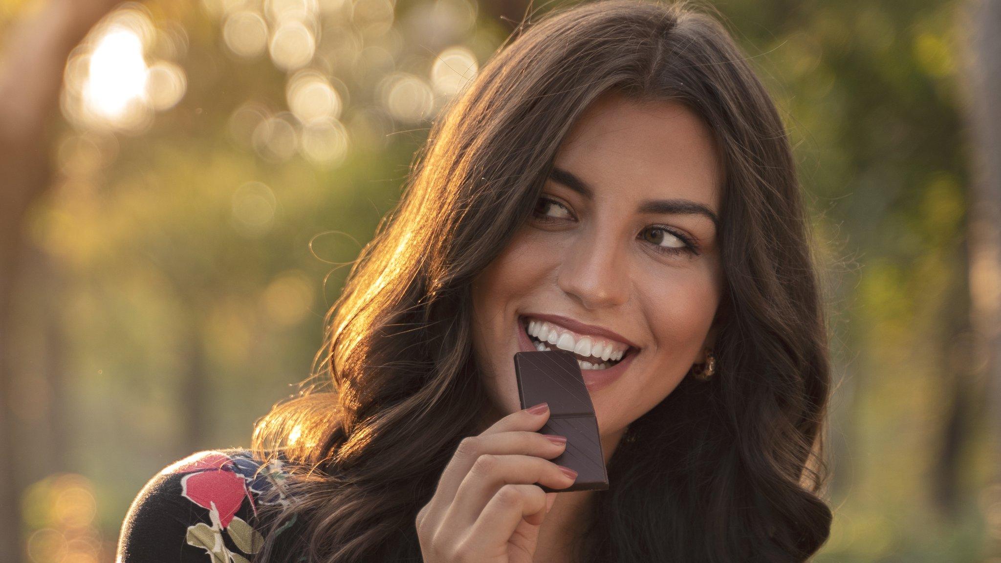 Stock shot of woman eating chocolate