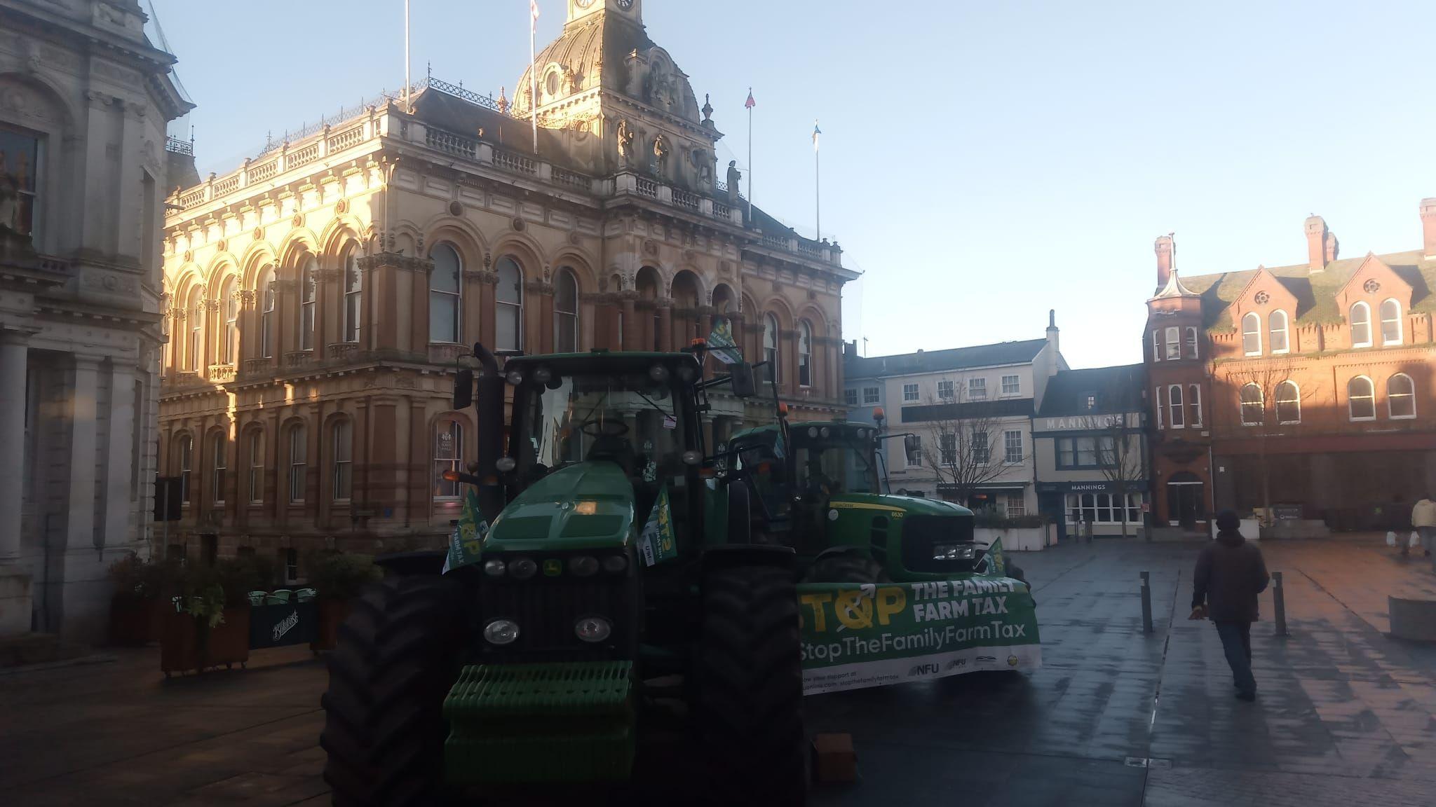 big green tractor manoeuvring through Ipswich town centre