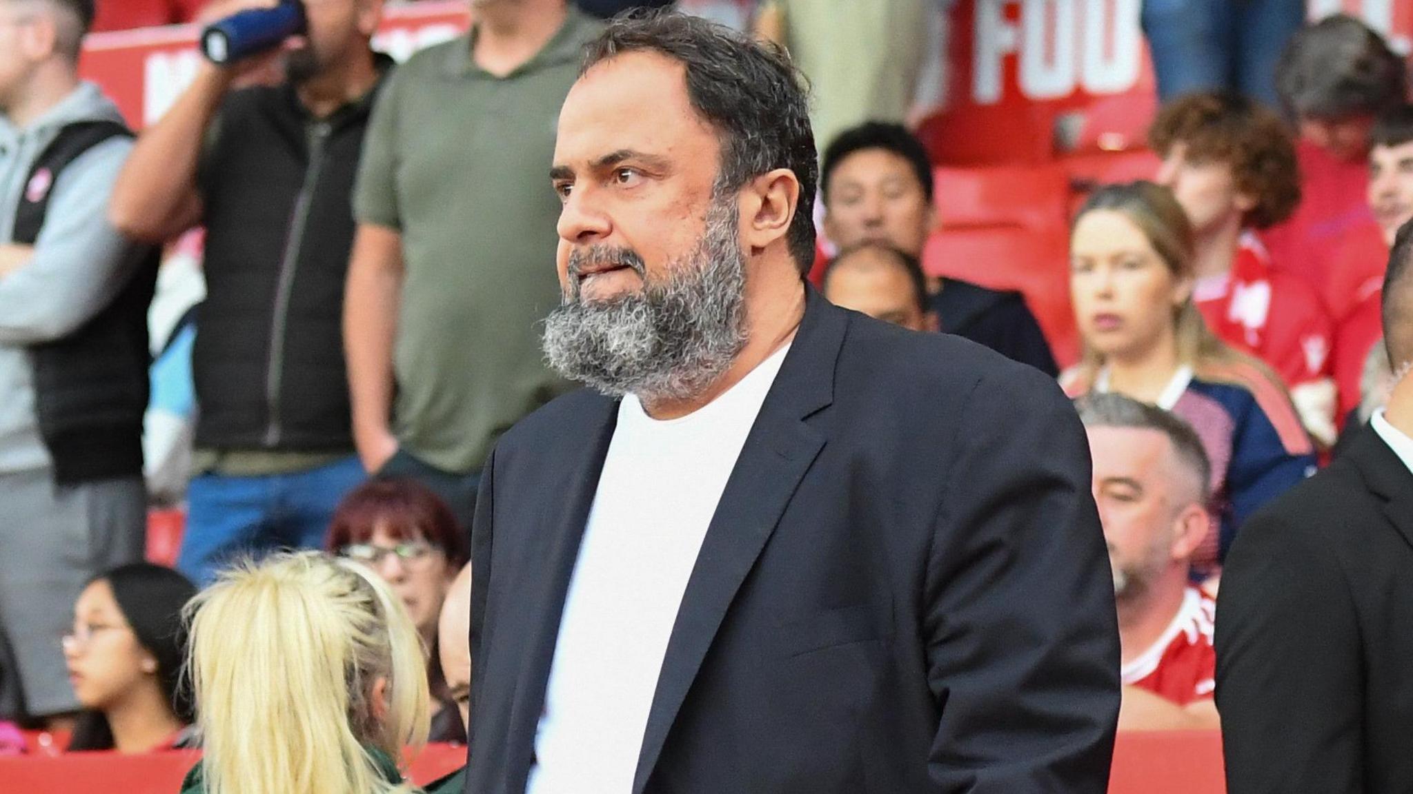 Evangelos Marinakis, standing looking at the City Ground pitch, was charged with misconduct.