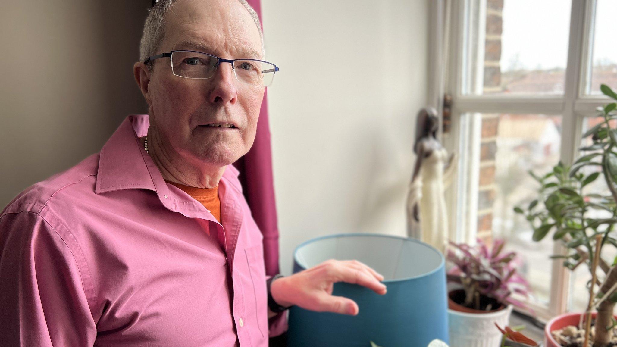 Resident Keith Sturgess stands by his Salisbury flat window