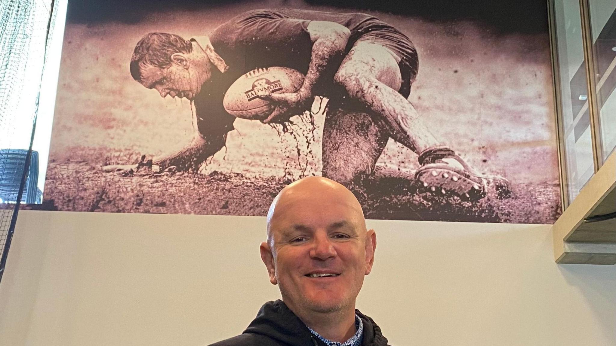 Welshman Tony Rees with the picture in a Brisbane gym of himself as a player that is known as the "Ballymore Man"