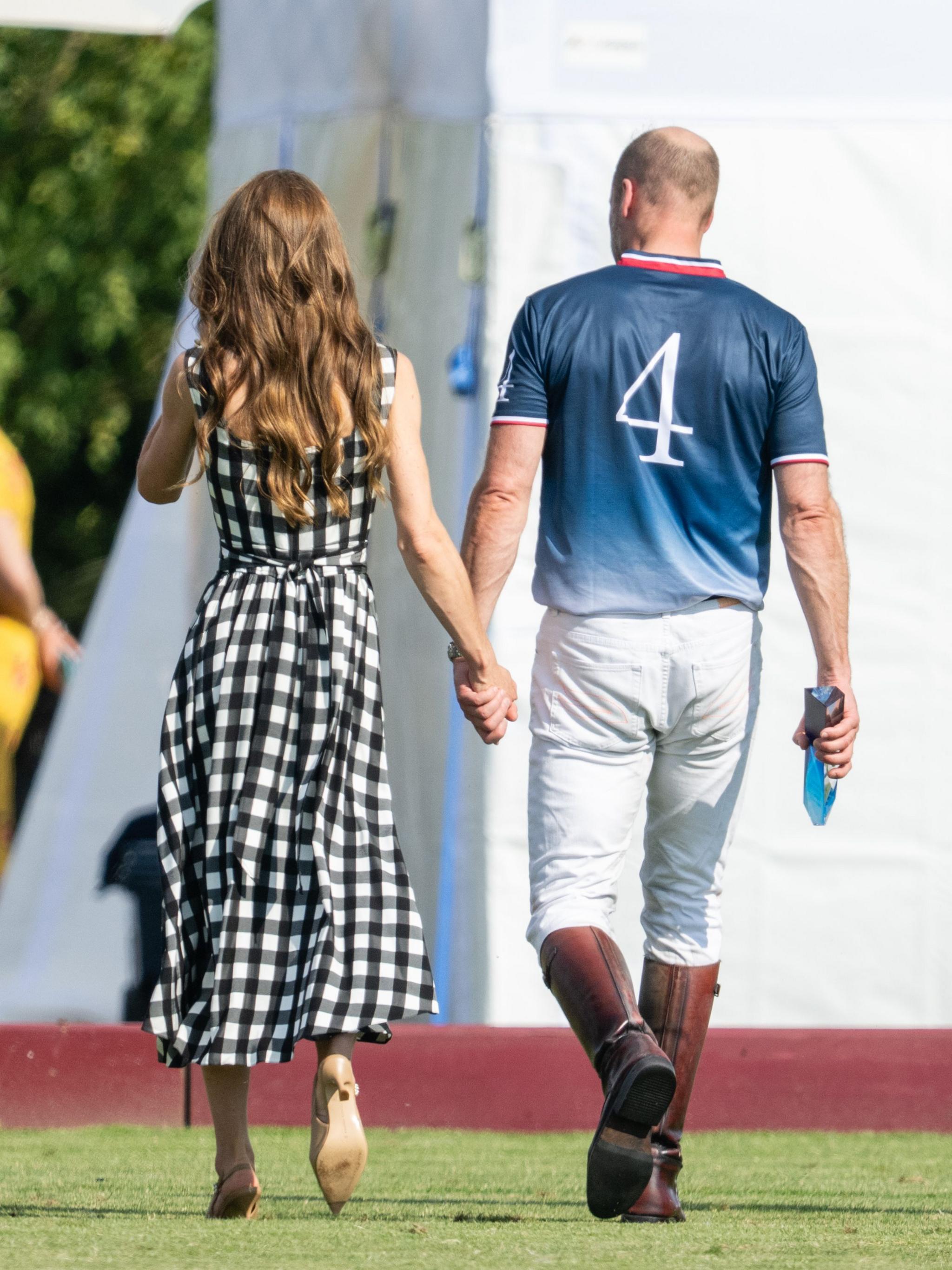 A picture of the Princess of Wales on the left and the Prince of Wales walking away after the polo match.