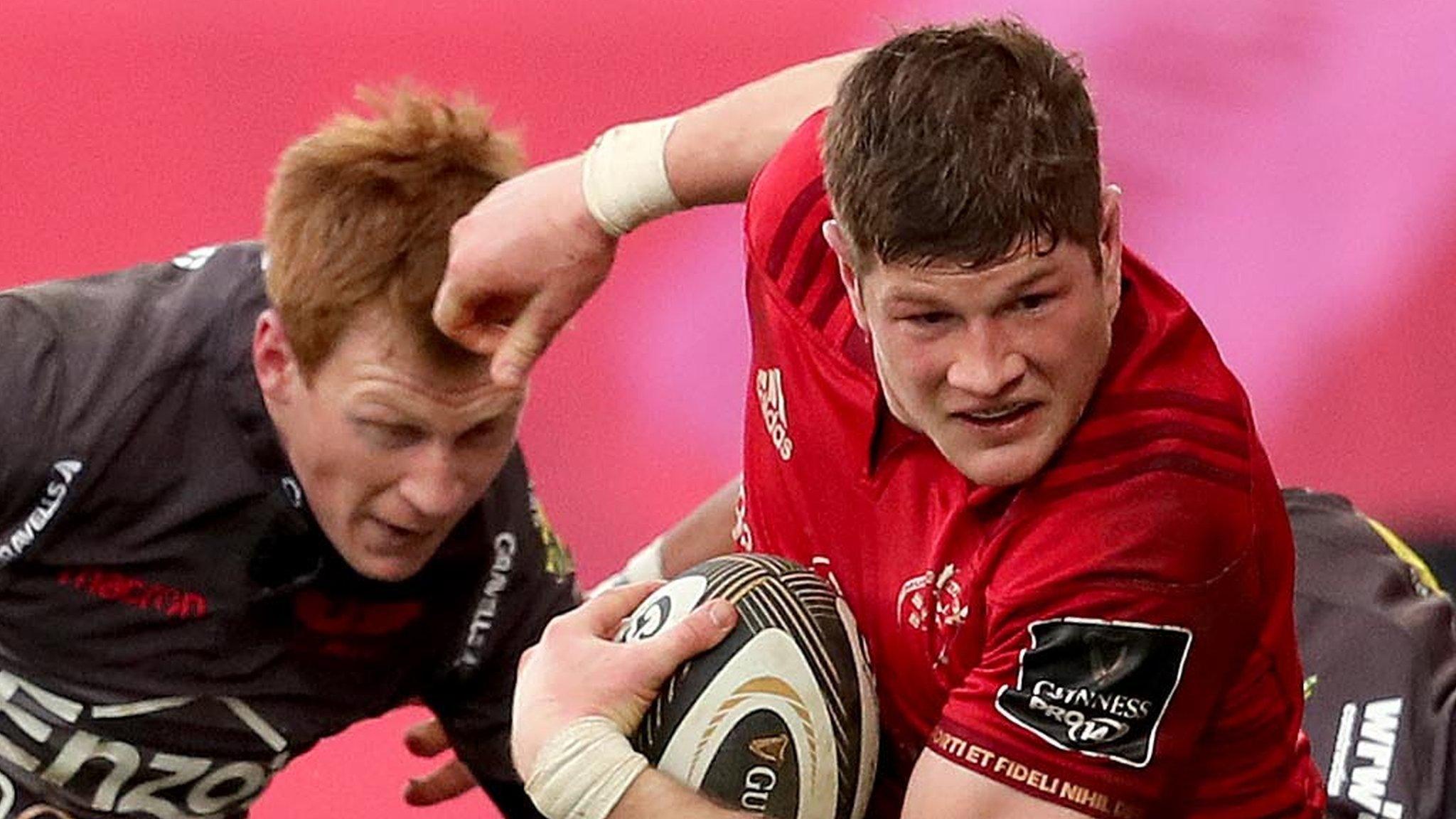 Munster's Jack O'Donoghue battles with Scarlets fly-half Rhys Patchell