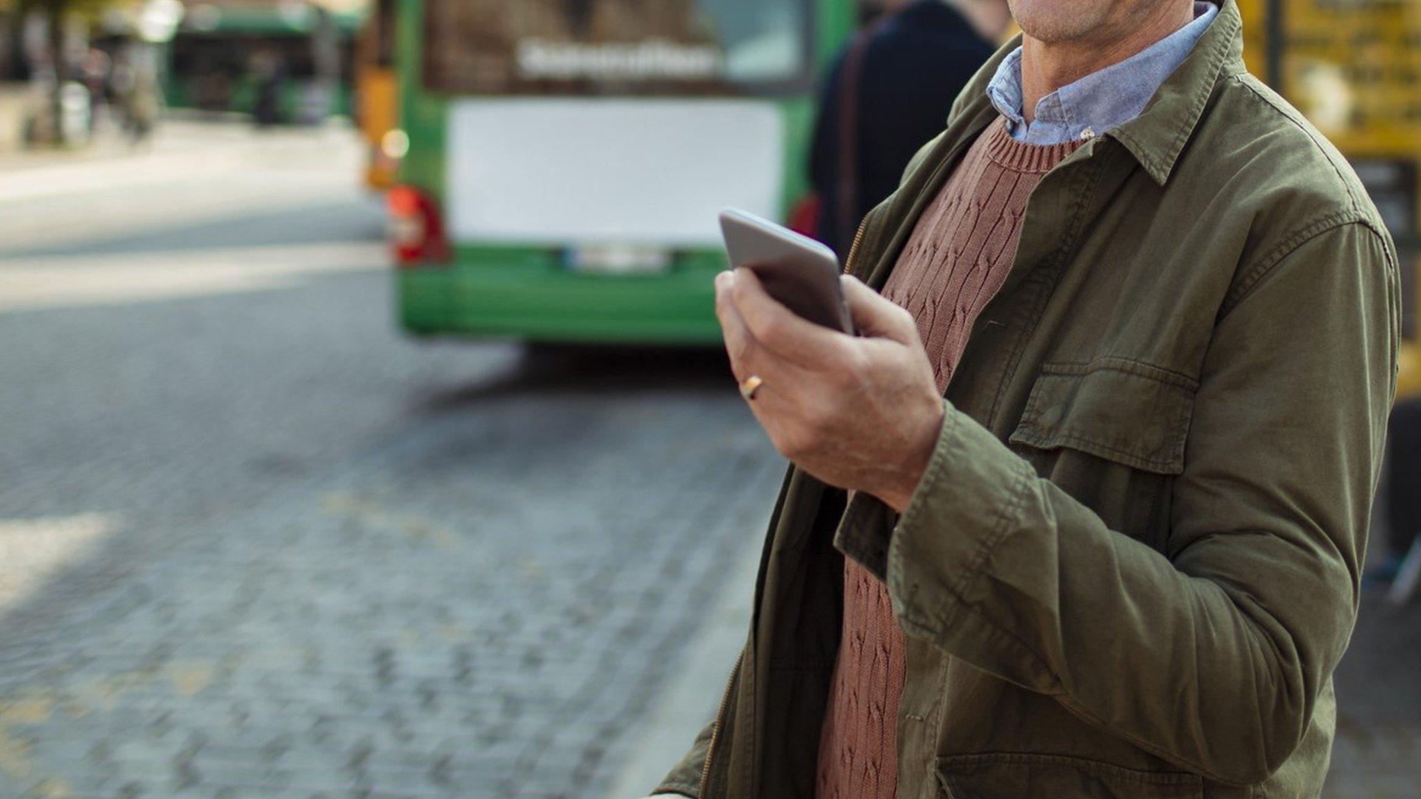 Man on phone near bus