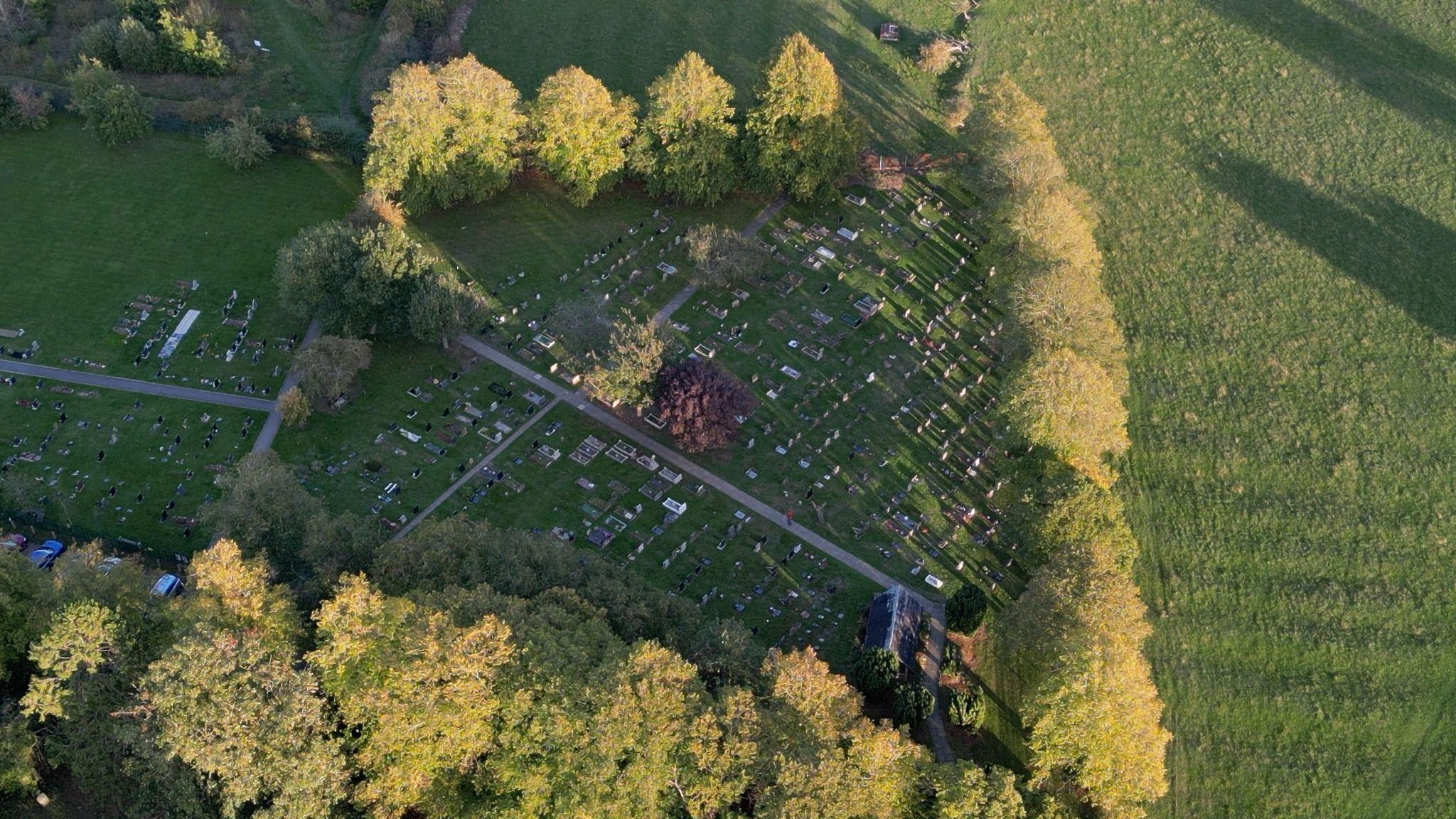 An aerial shot of Studley Cemetery showing rows of graves, surrounded by trees.