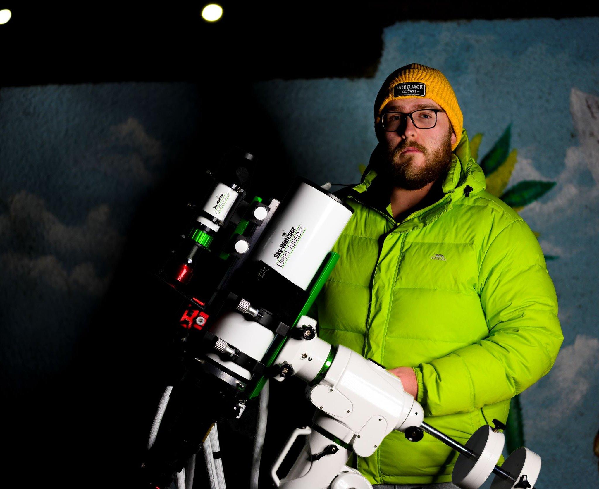 Bryan Shaw holding a telescope