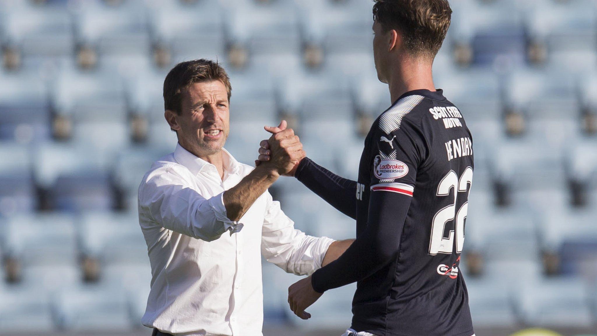 Dundee manager Neil McCann celebrates the win with Jack Hendry