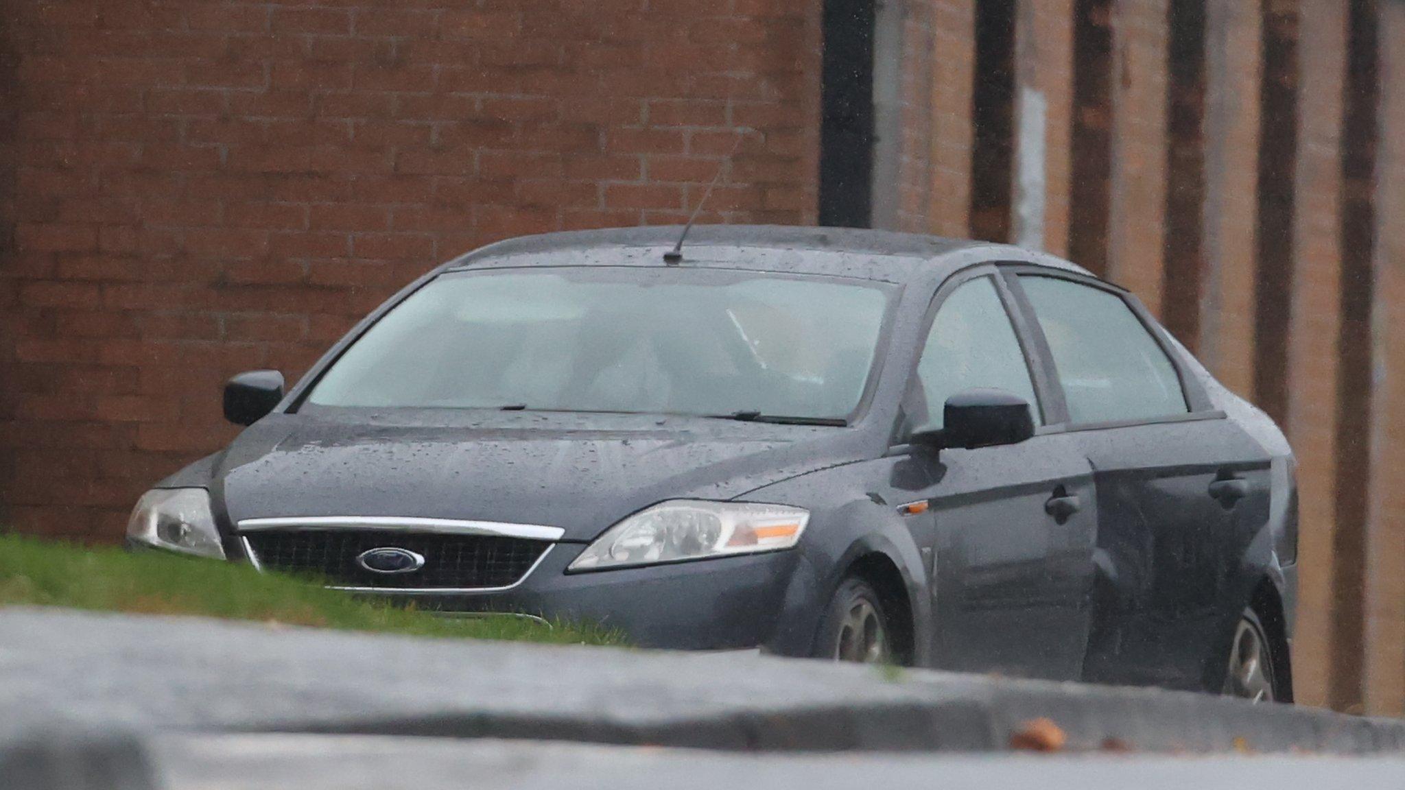 The grey Ford Mondeo in which the bomb was placed sits outside the Waterside Police Station in Londonderry