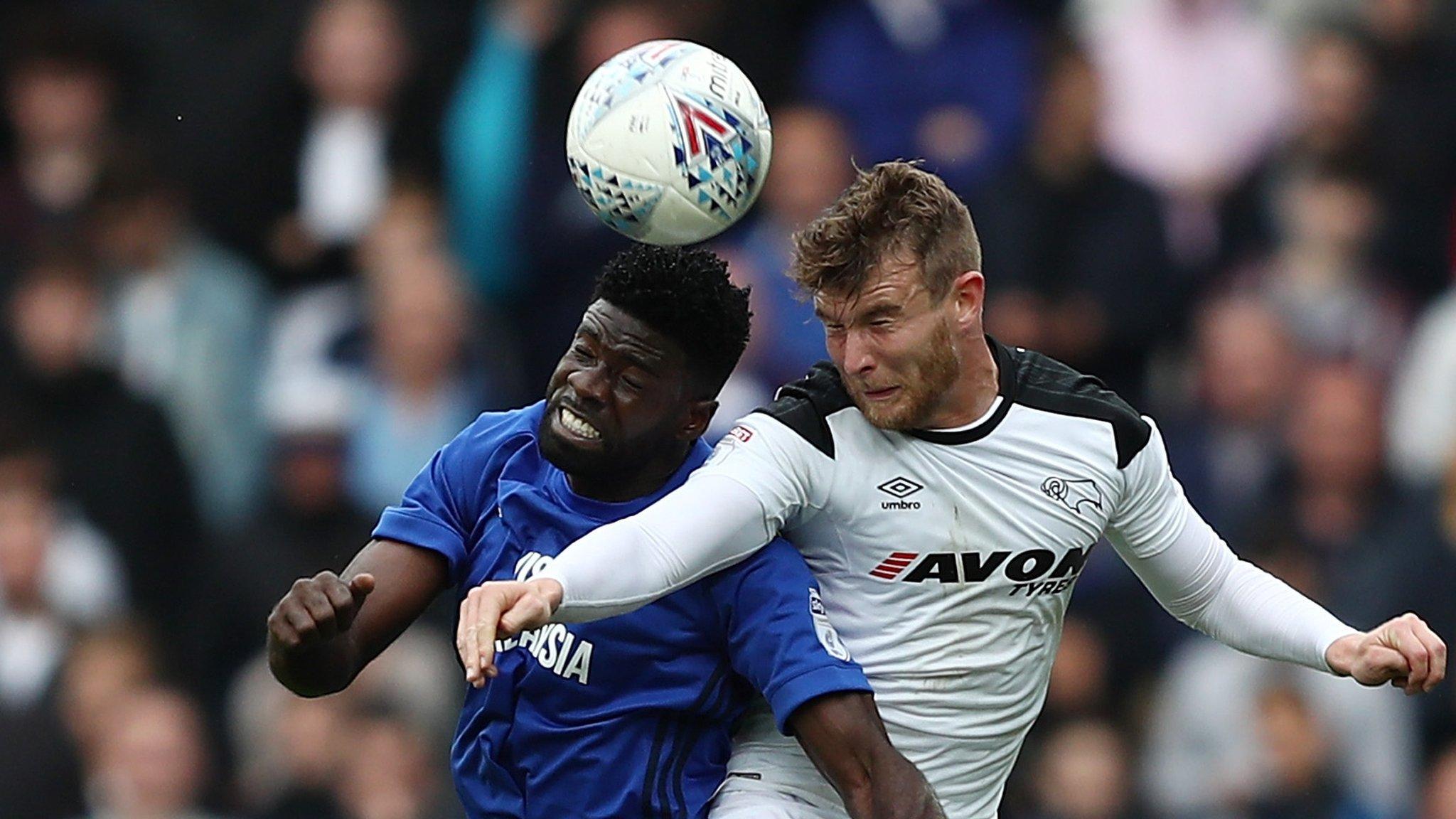 Bruno Ecuele Manga of Cardiff City challenges for the ball with Sam Winnall of Derby County