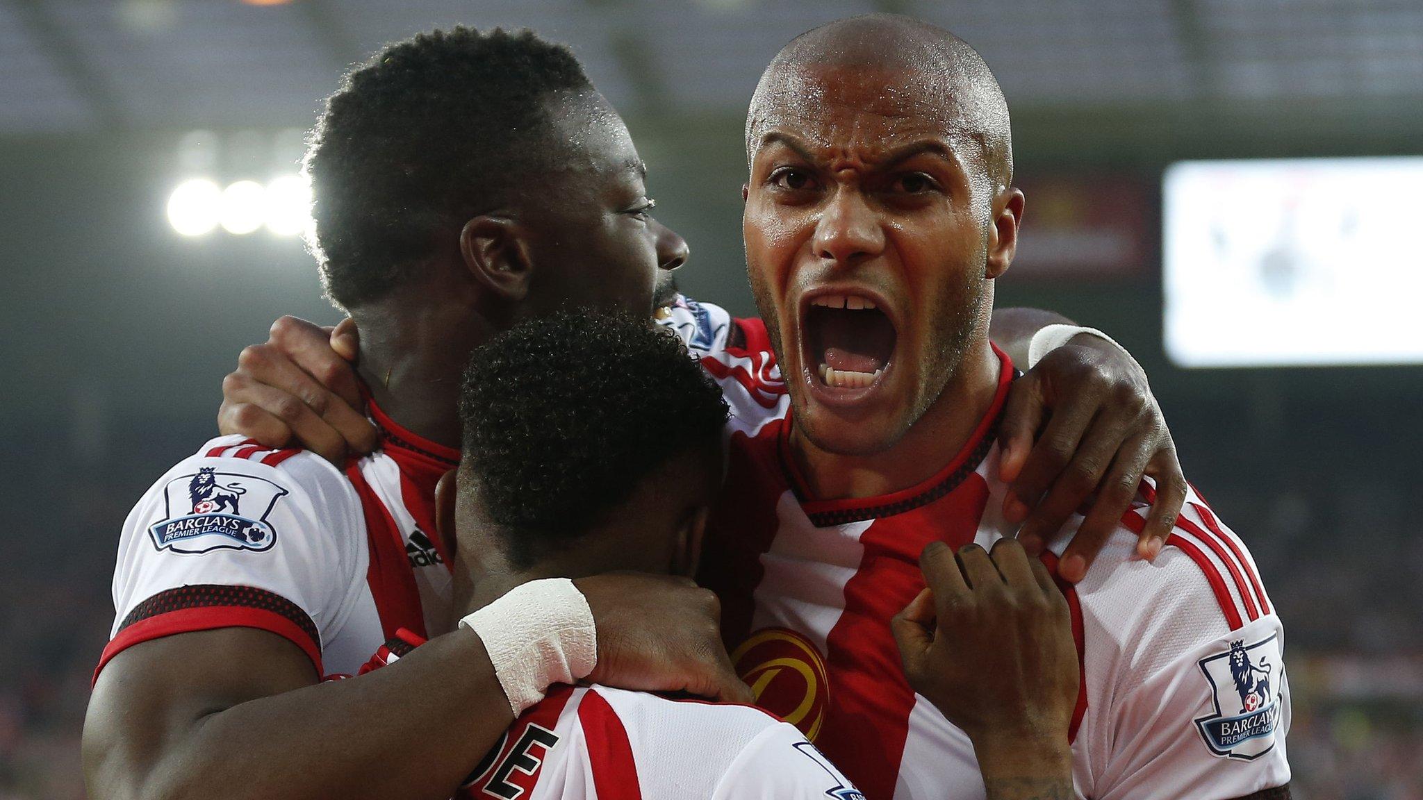 Lamine Kone celebrates with team-mates, including Younes Kaboul (right)