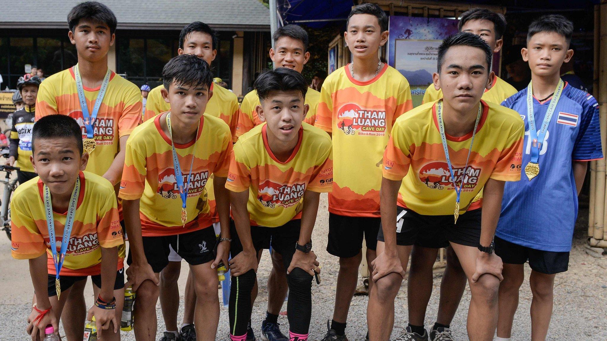 Members of the 'Wild Boars' football team and their coach