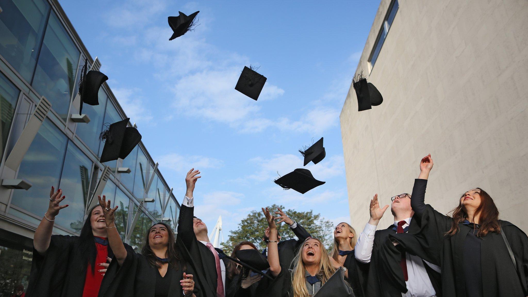 Students throwing hats in the air