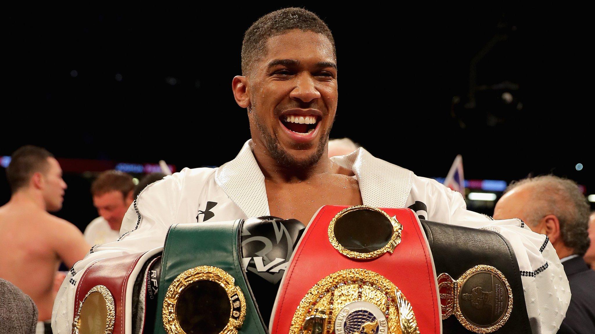 Anthony Joshua with belts