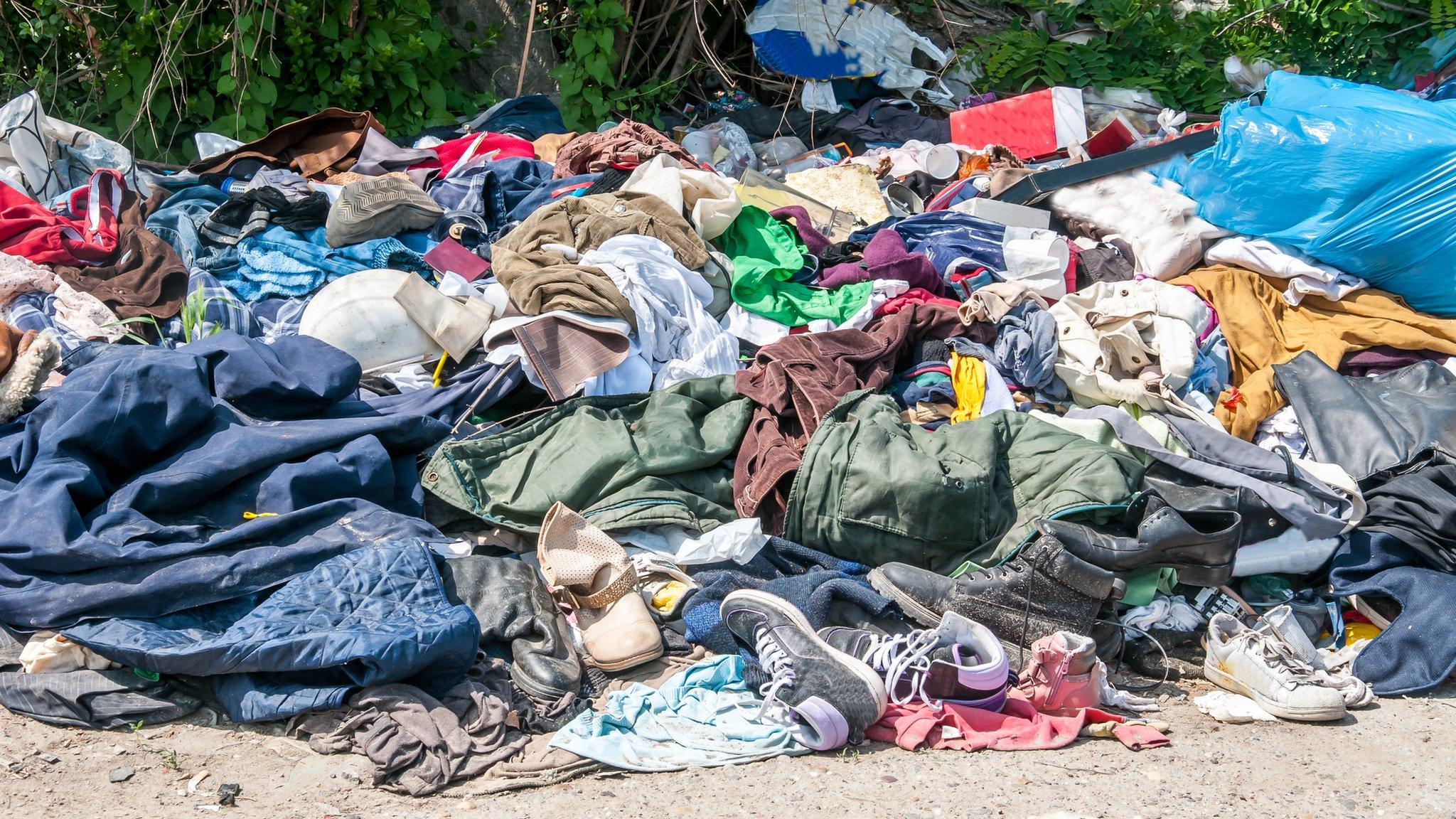 Discarded clothes on a rubbish pile.