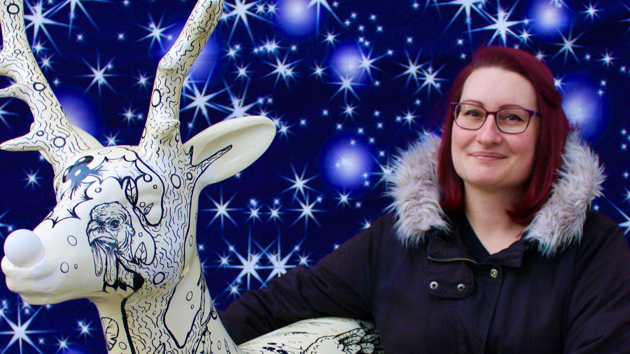 Artist Lydia Hartley with a painted reindeer