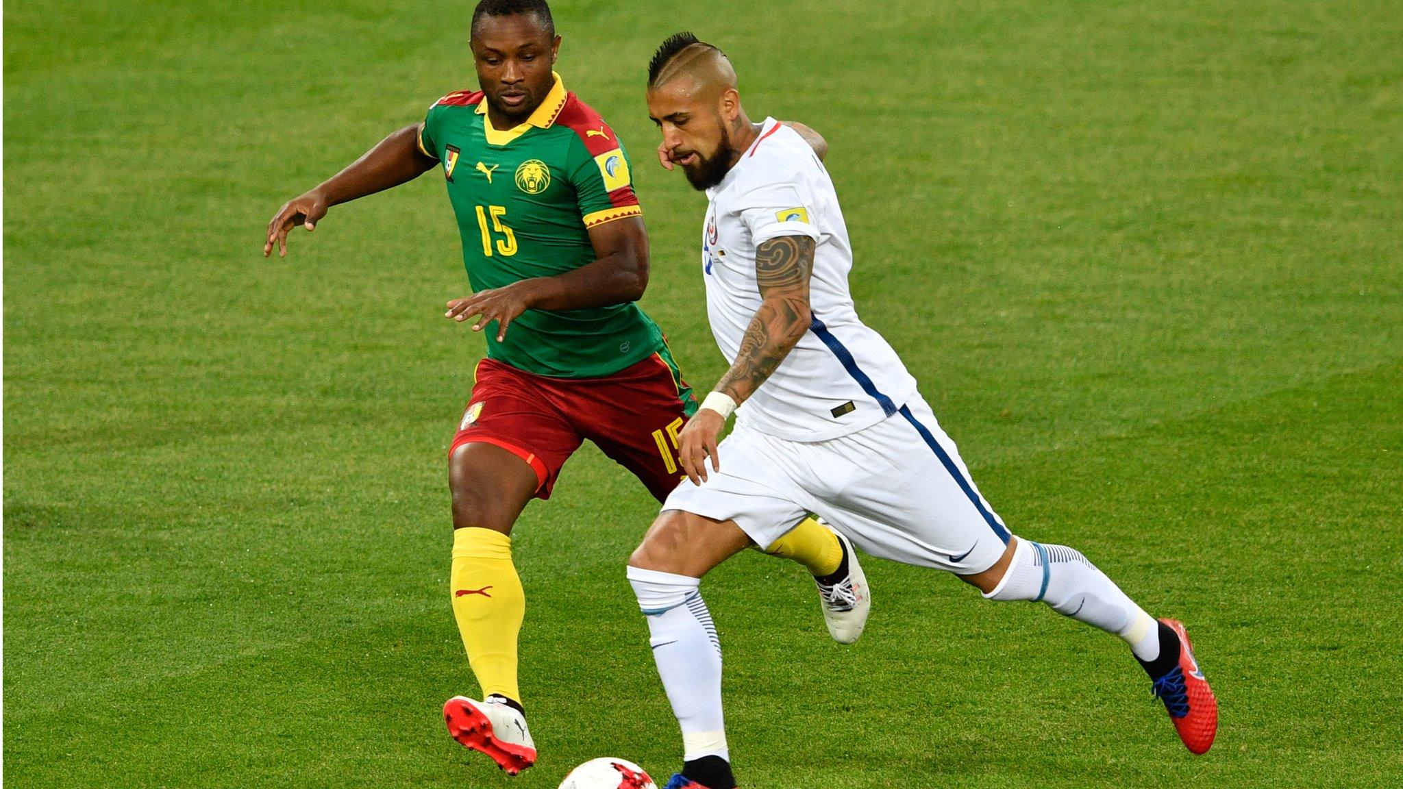 Cameroon's Sebastian Siani (left) battles for the ball with Chile's Arturo Vidal