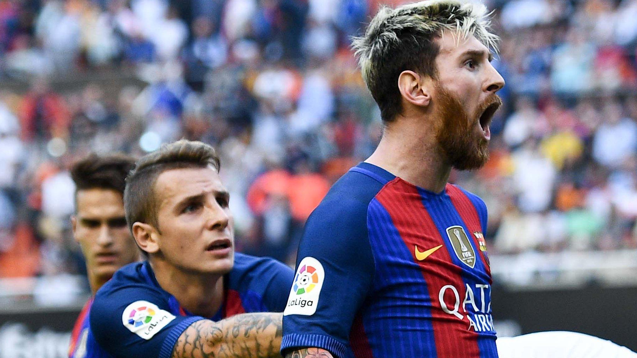 Lionel Messi reacts to bottle thrown by Valencia fan