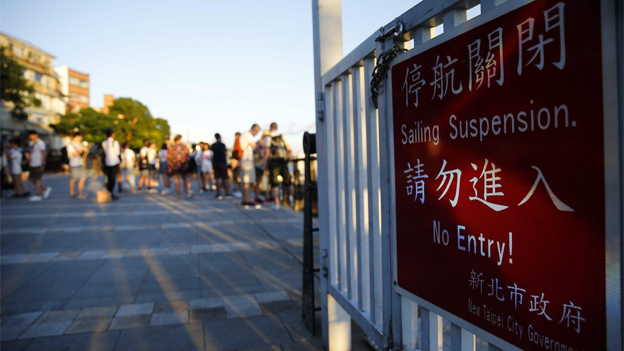 A sailing suspension advisory is posted a port gate in anticipation for typhoon Nepartak at the port area in New Taipei City, Taiwan, 06 July 2016.