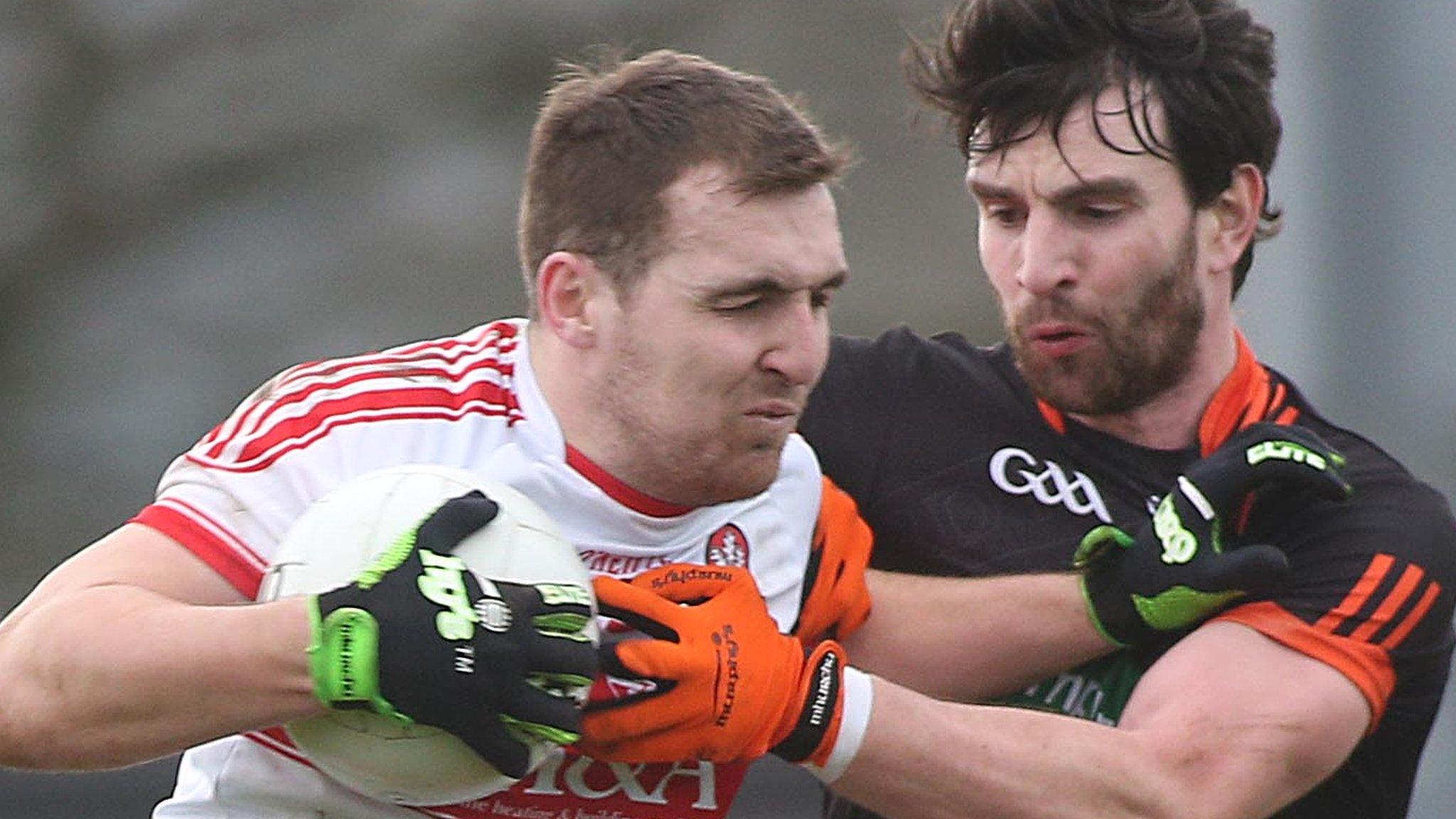 Derry forward Ryan Bell is tackled by Armagh's Aaron Findon