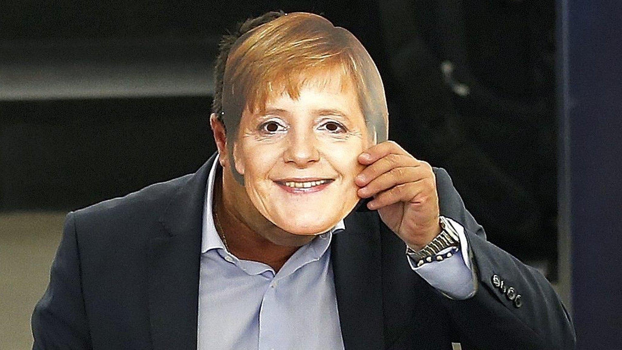 Italian Member of the European Parliament Gianluca Buonanno wearing a mask depicting German Chancellor Angela Merkel