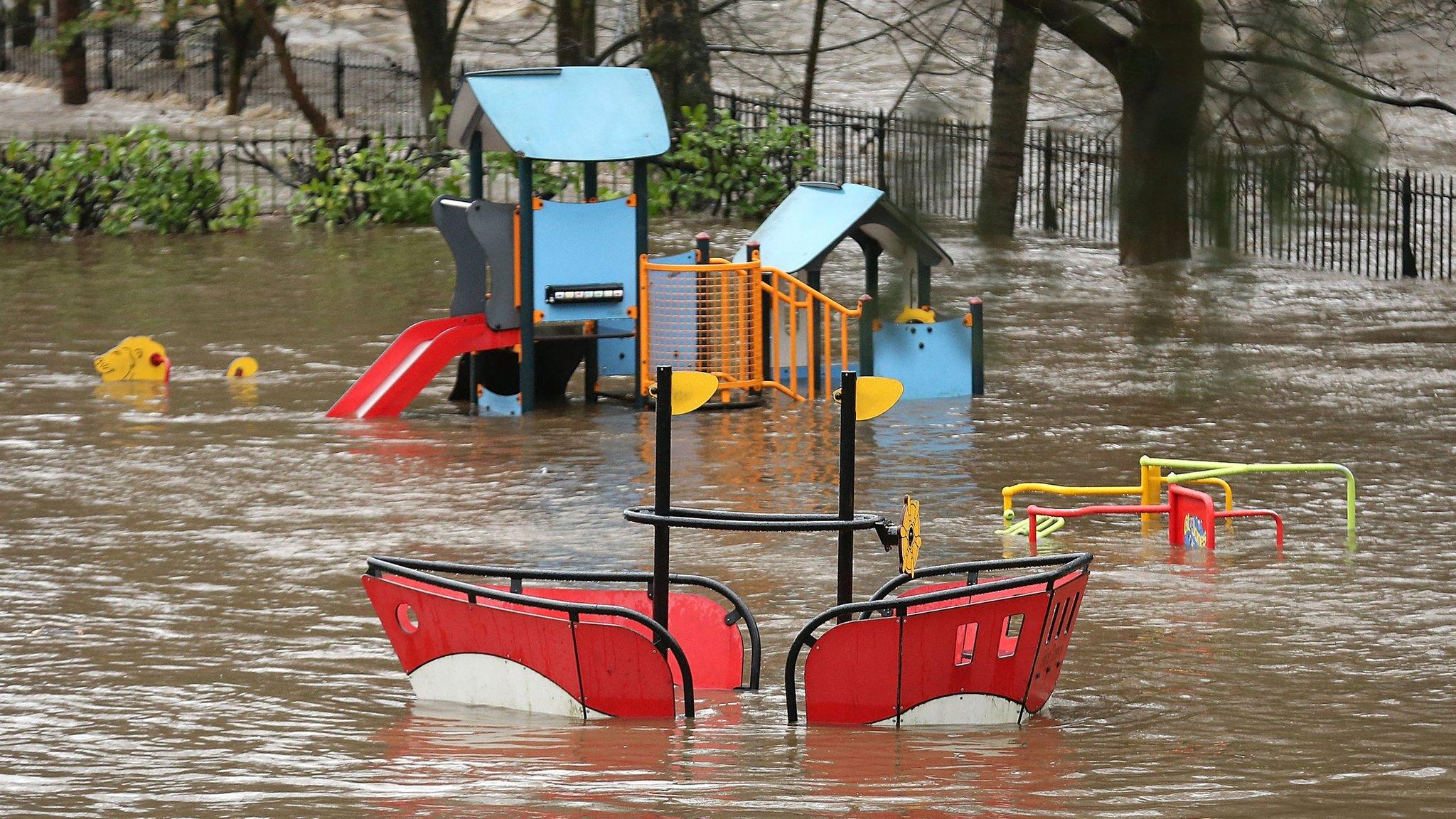 A playground is flooded as rivers burst their banks on in Hebden Bridge, England.