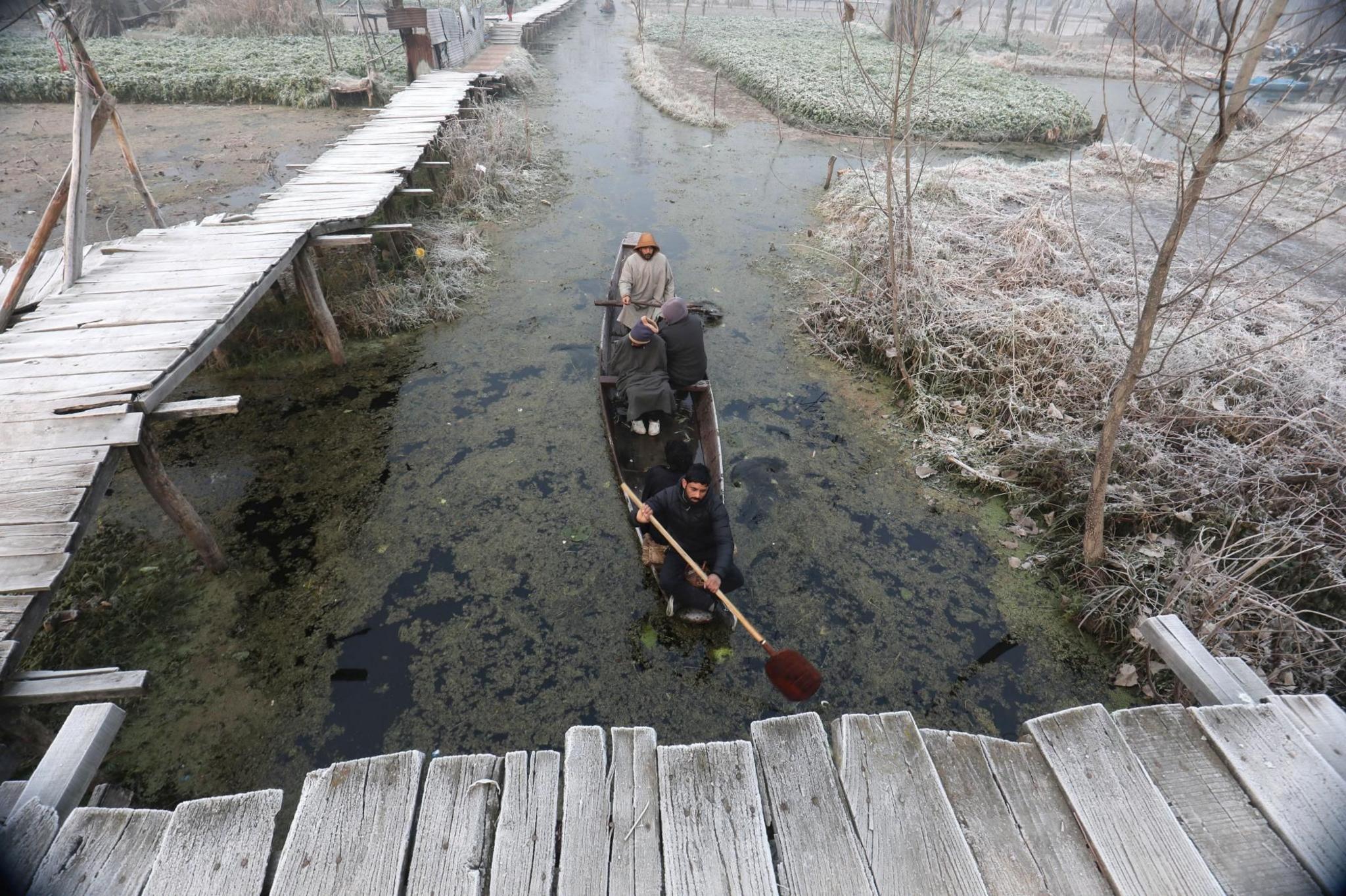 A boat near the shores of Dal Lake on a cold morning in Srinagar