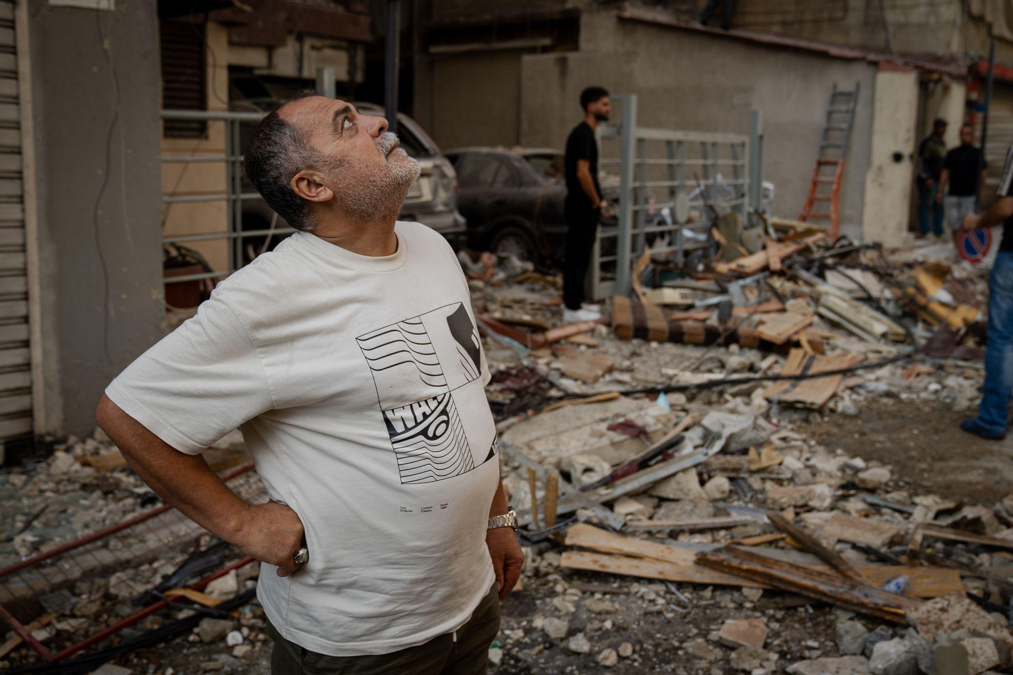 Musa Araf, looks up at his damaged building, which shook violently when the missile hit.