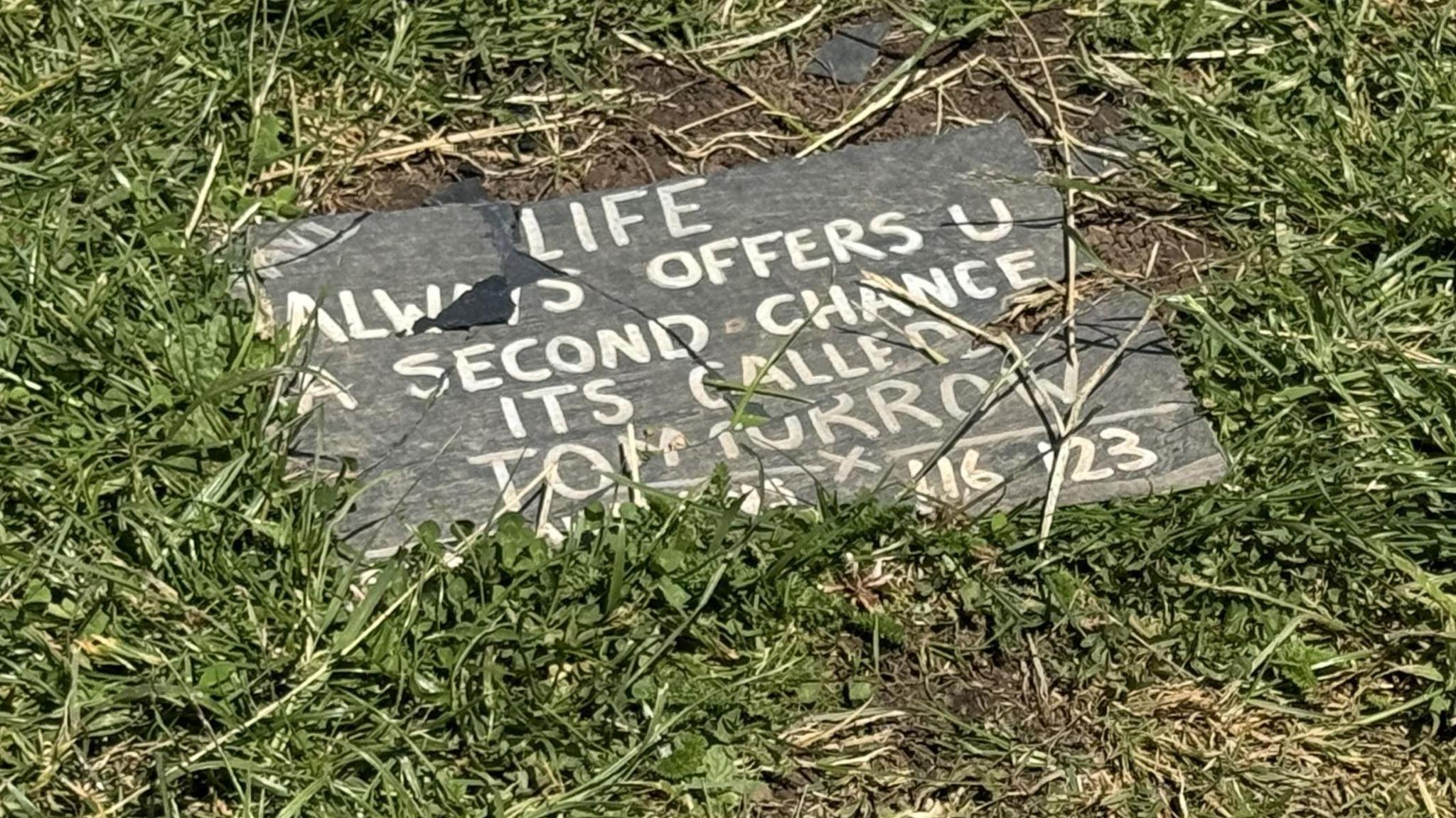 An image of a slate sign displaying a message