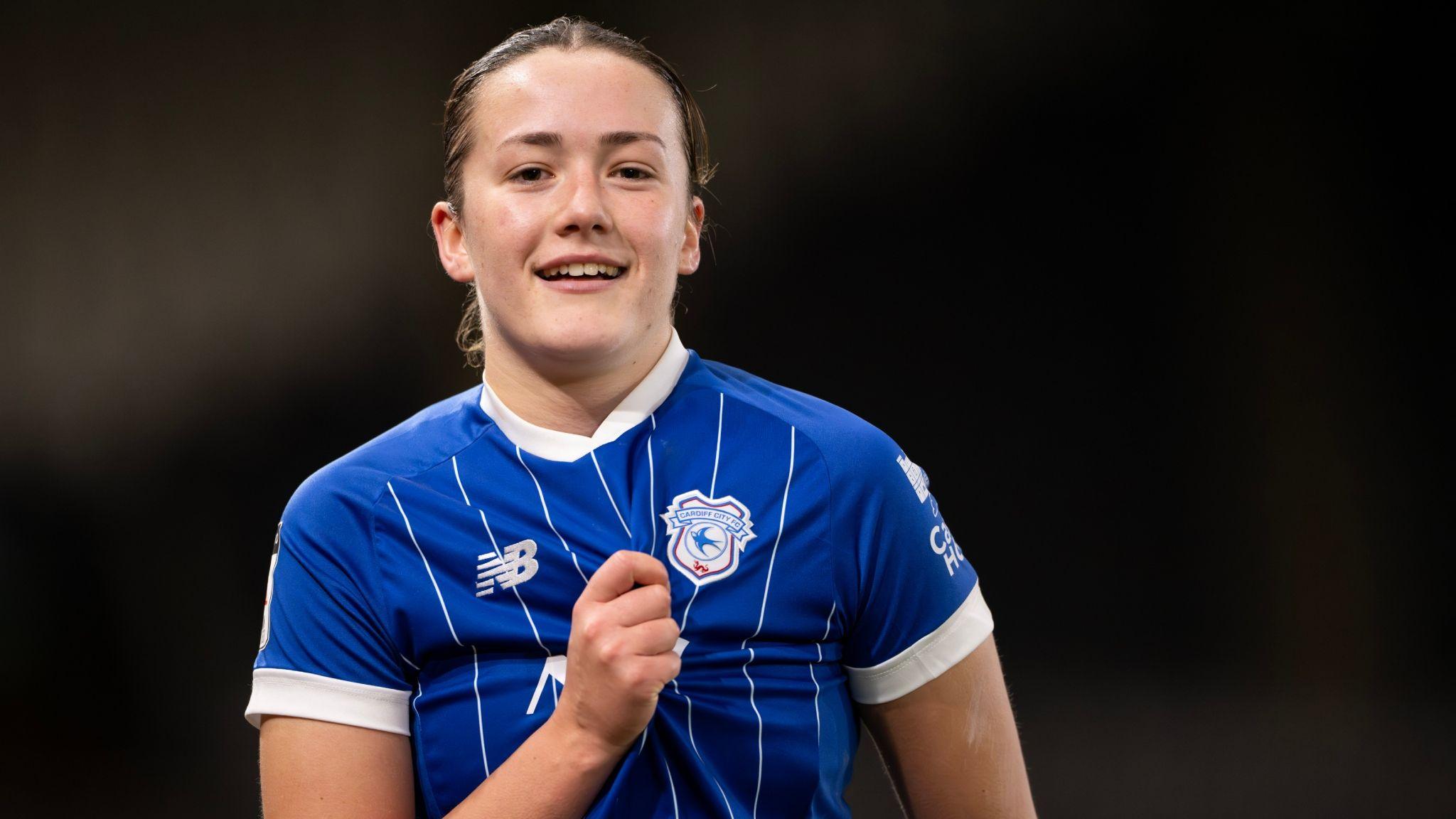 Cardiff City's Nieve Jenkins clutches shirt to highlight badge