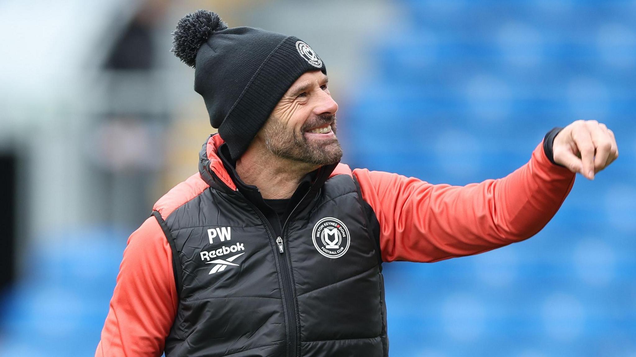 A smiling MK Dons boss Paul Warne