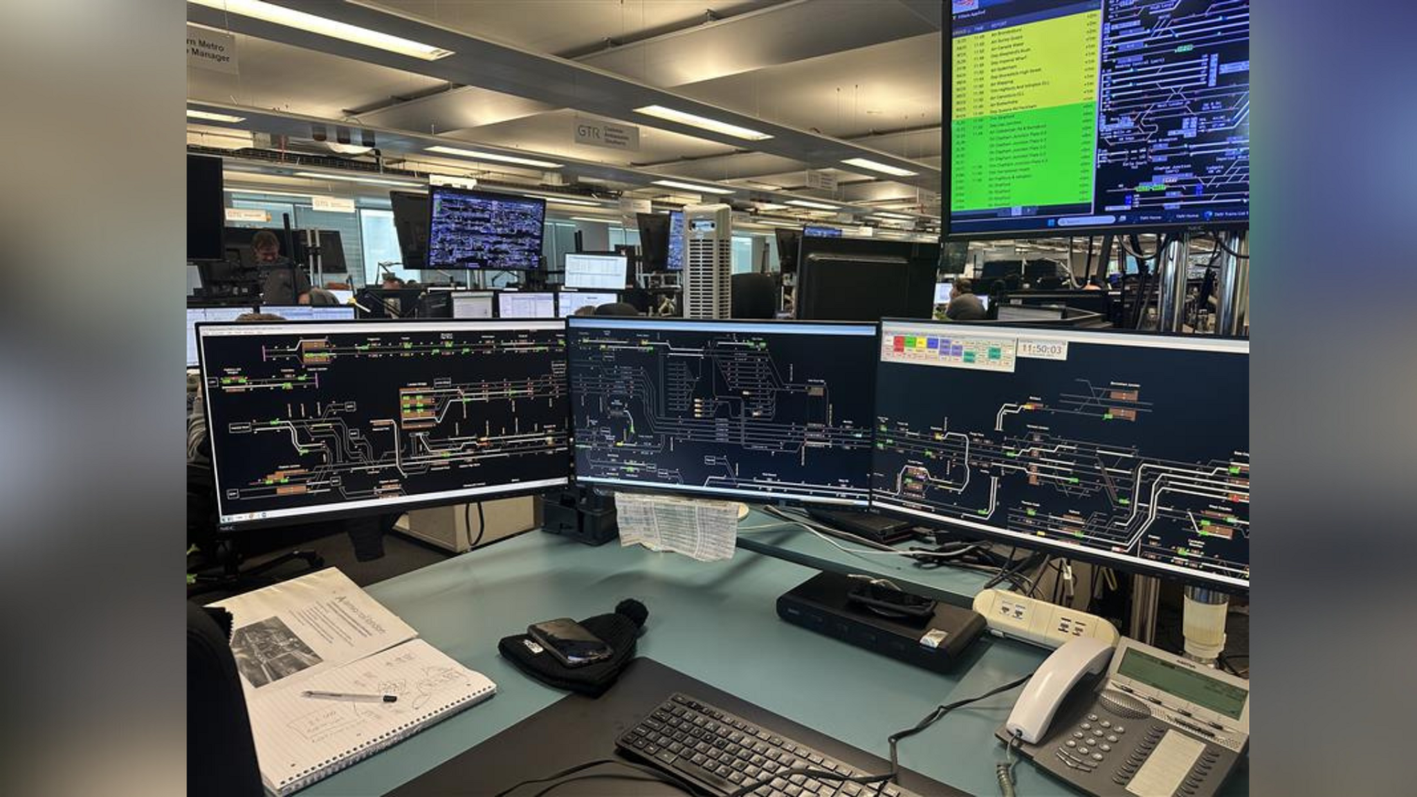 Three separate computer monitors detailing the railway lines in Sussex and the South East.
