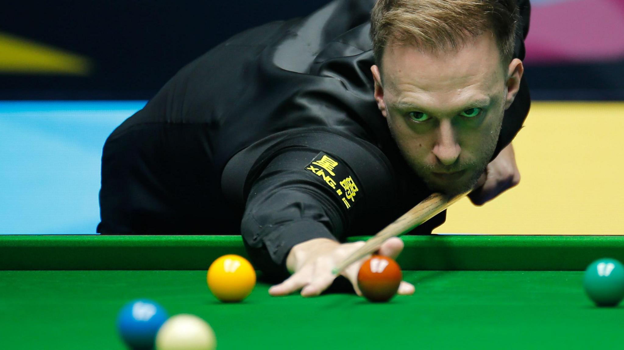 Judd Trump plays a shot
