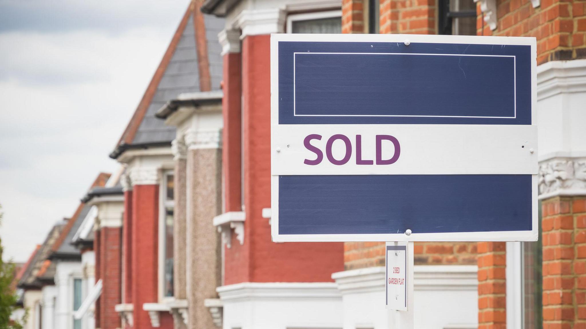 A generic for sale sign outside a house