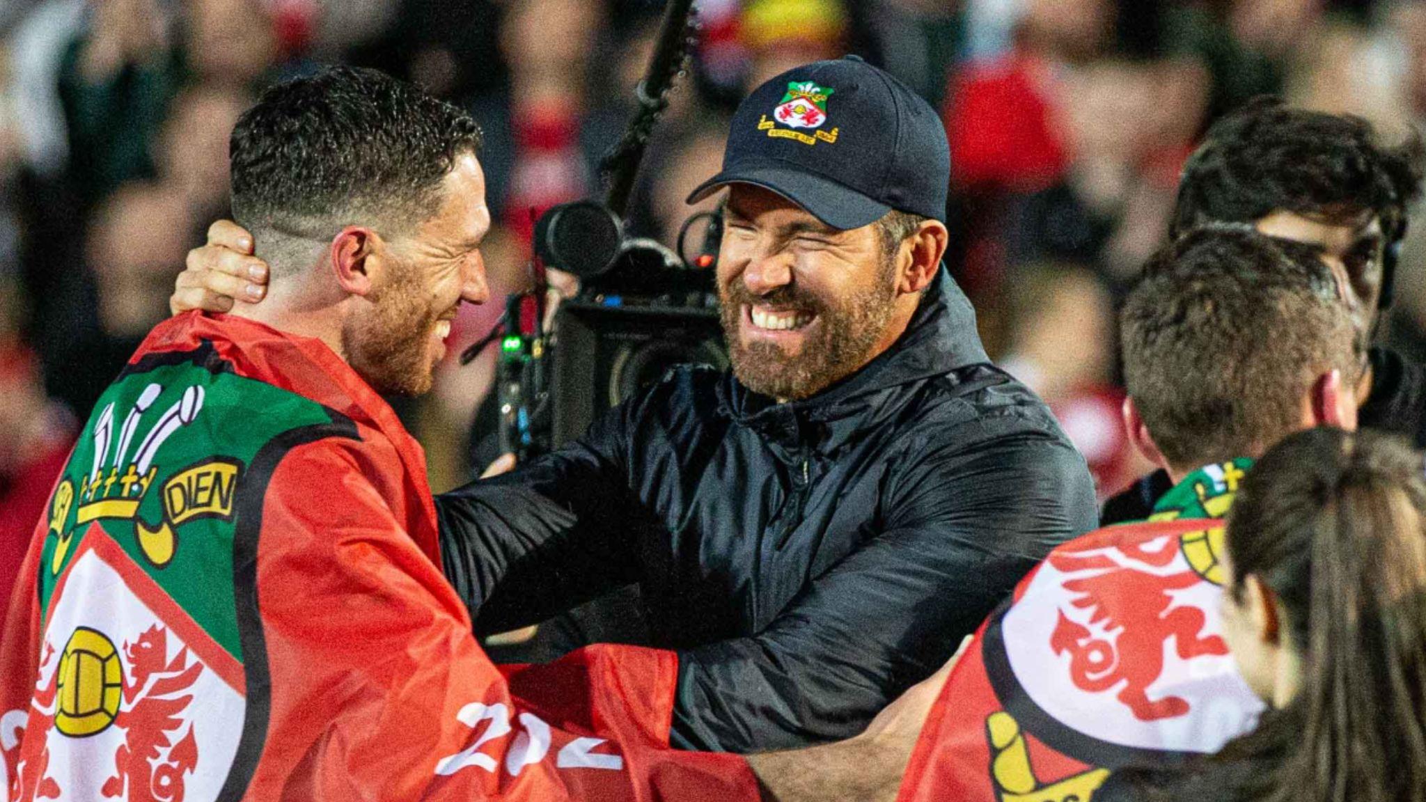Ben Tozer is embraced by Ryan Reynolds after securing the National League title