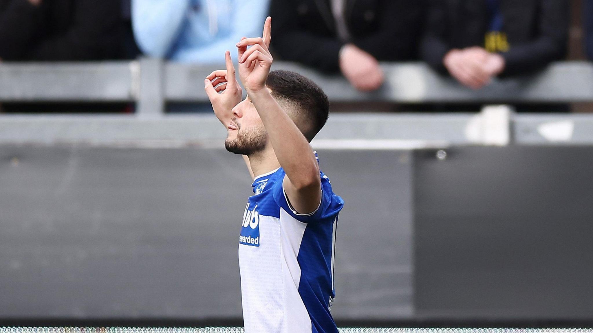 A Bristol Rovers players points to the sky as he celebrates scoring against Huddersfield Town at the Memorial Stadium