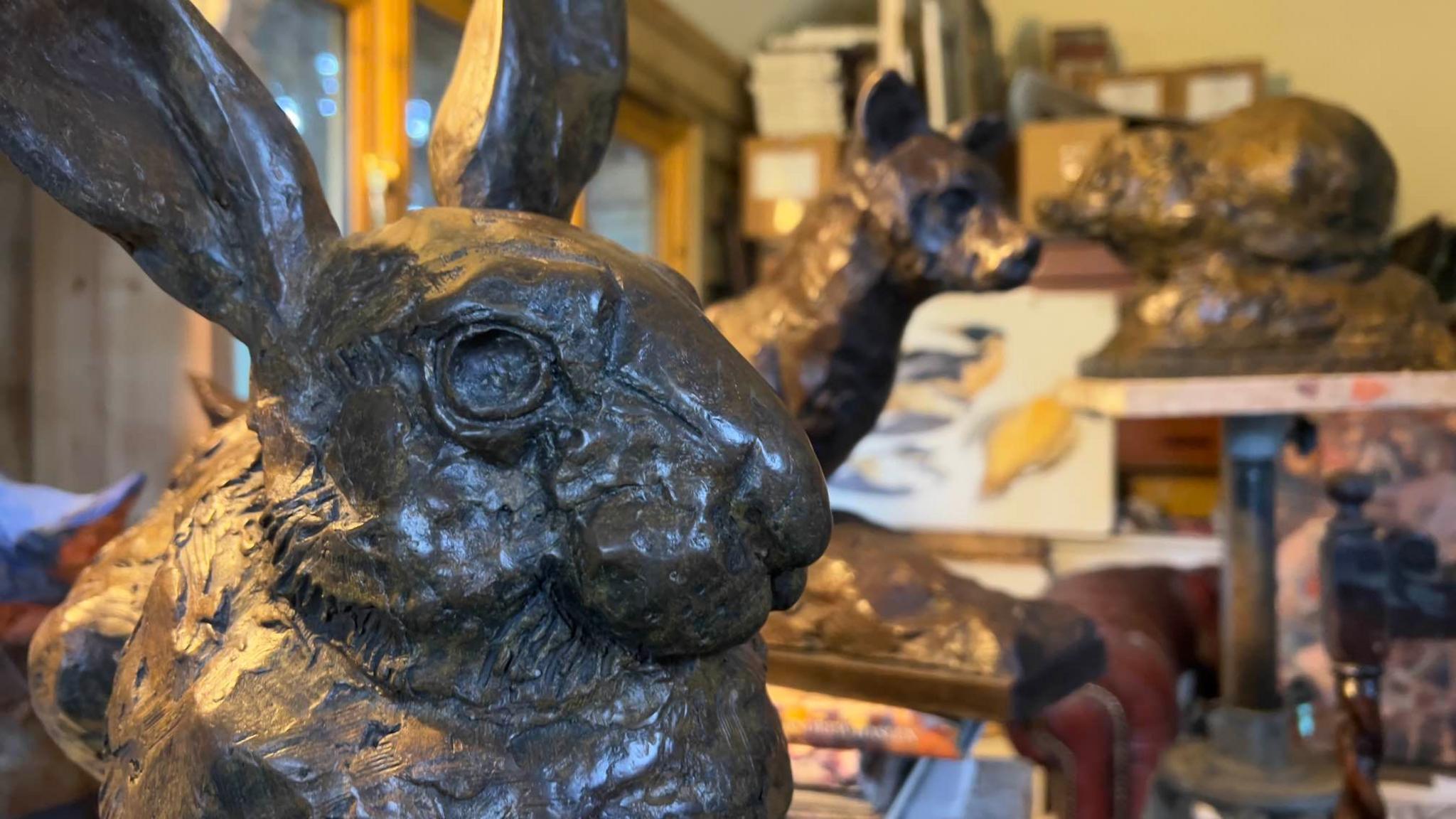 Another of Mr Haslen's bronze sculptures of a hare is pictured. Several other sculptures sit behind it included one of a fox.