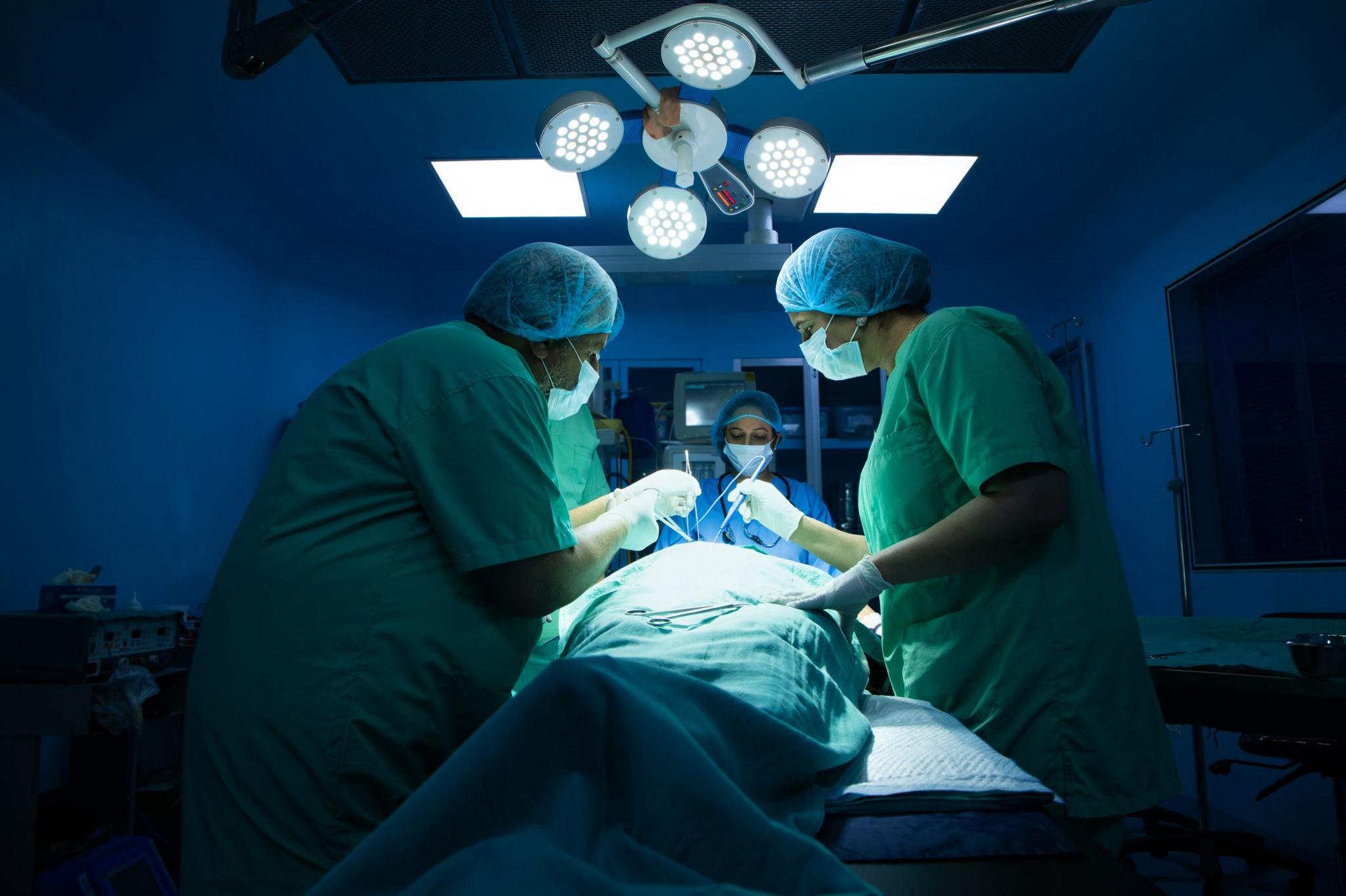 Indian surgeons medical team performing surgery in operation theater at hospital