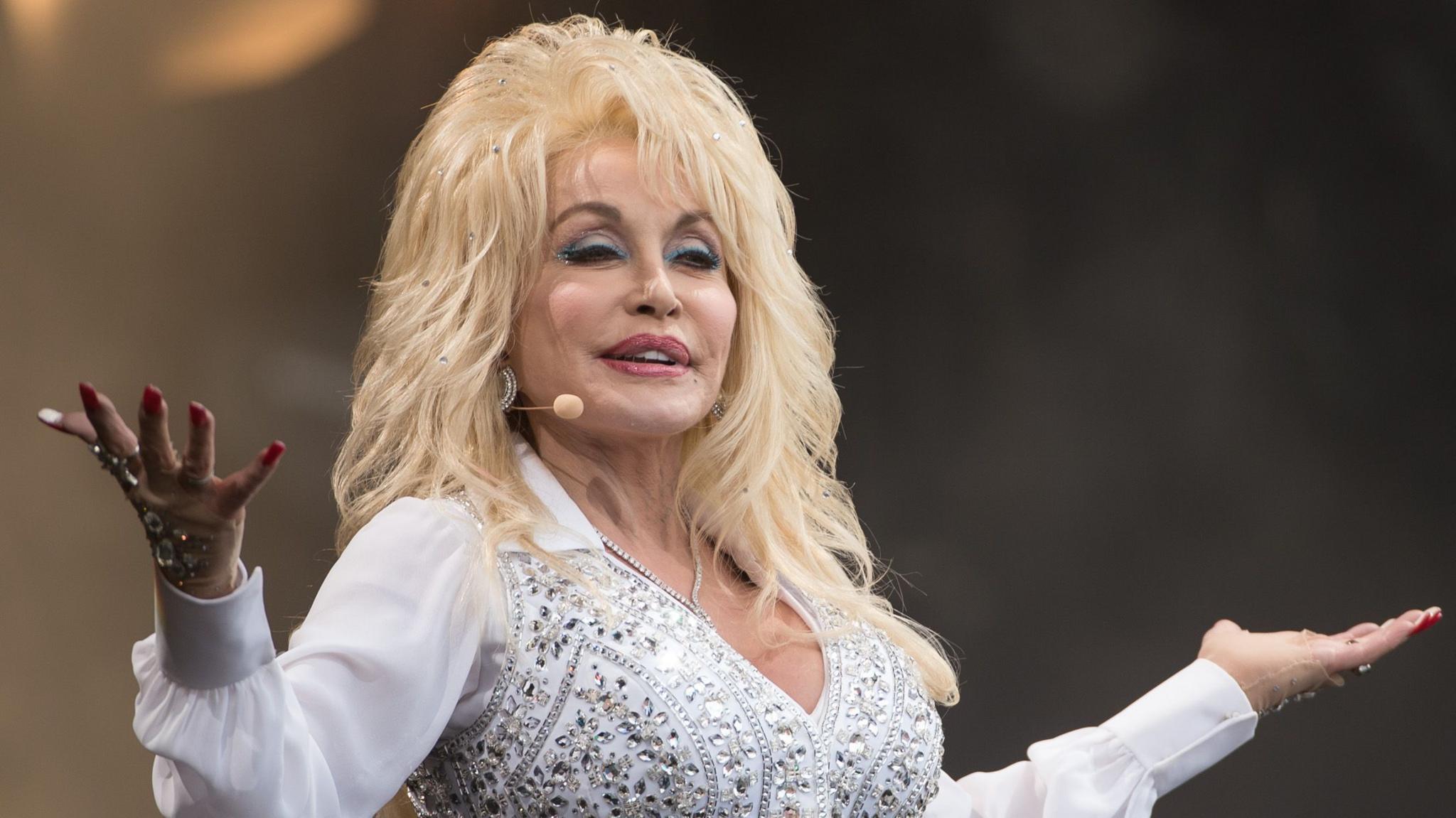 Dolly Parton in a white jewelled outfit