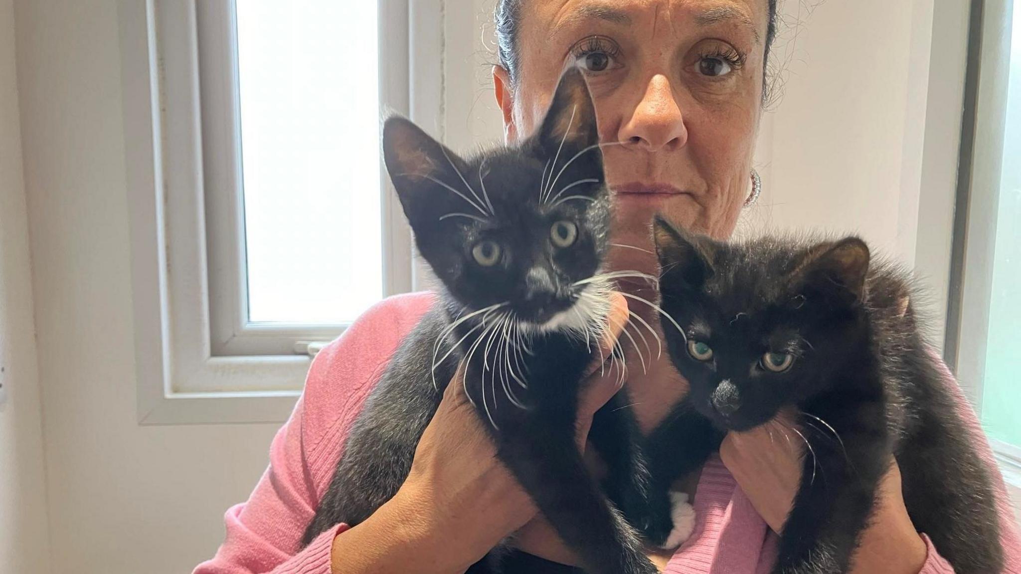 Sally Olford holding the two kittens