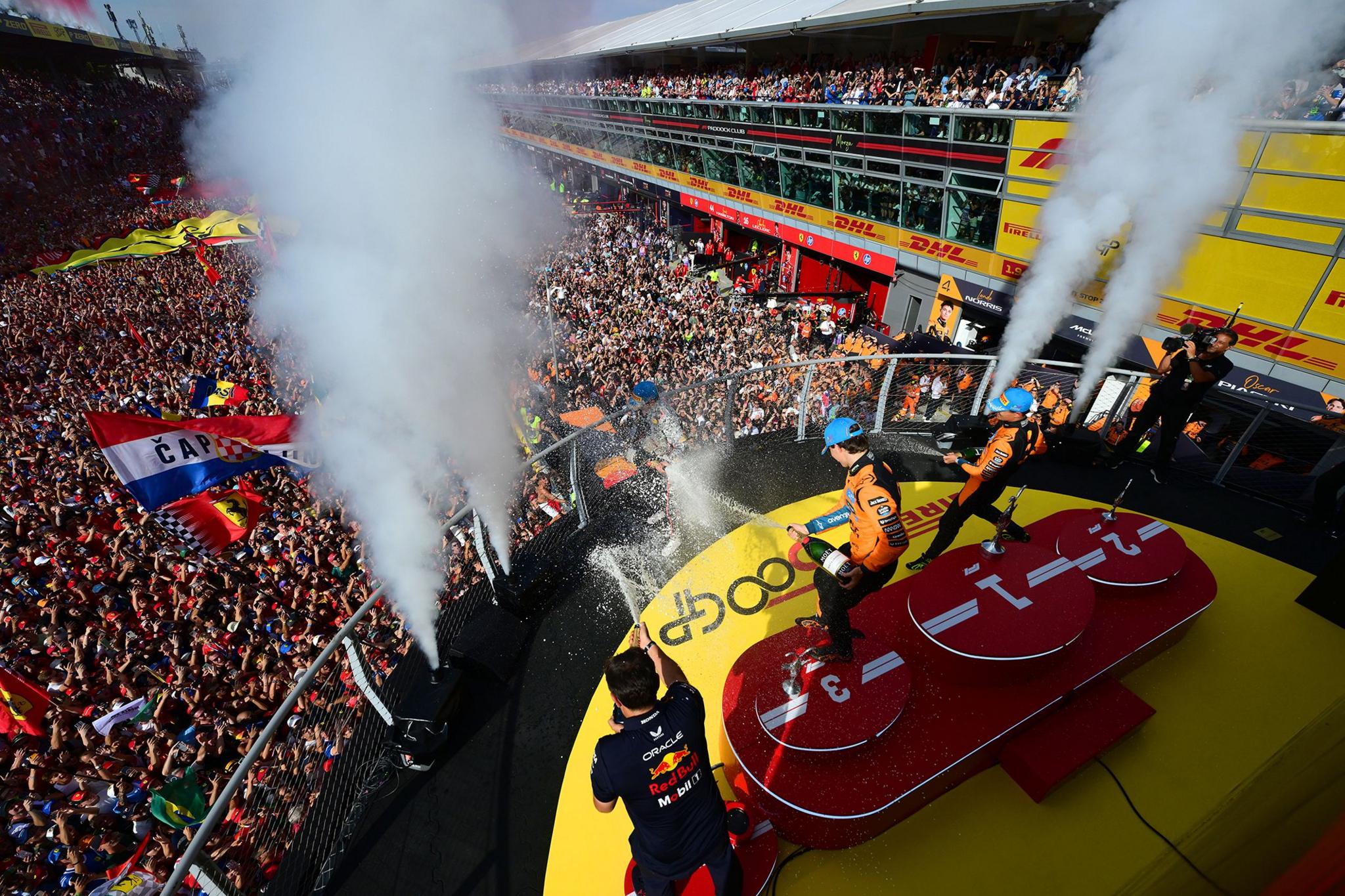 Race winner Max Verstappen of the Netherlands and Oracle Red Bull Racing Second placed Lando Norris of Great Britain and McLaren Third placed Oscar Piastri of Australia and McLaren and Pierre Wache, Technical Director of Oracle Red Bull Racing celebrate with Champagne on the podium. Photo by Mario Renzi