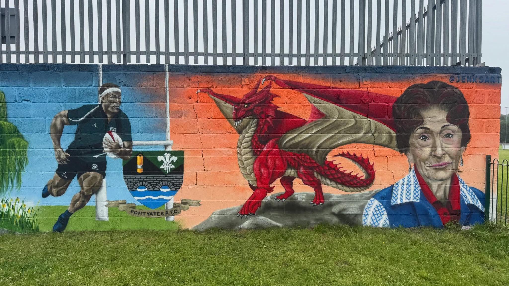 Mural in Pontyates featuring a rugby player, a red dragon and Dot Cotton