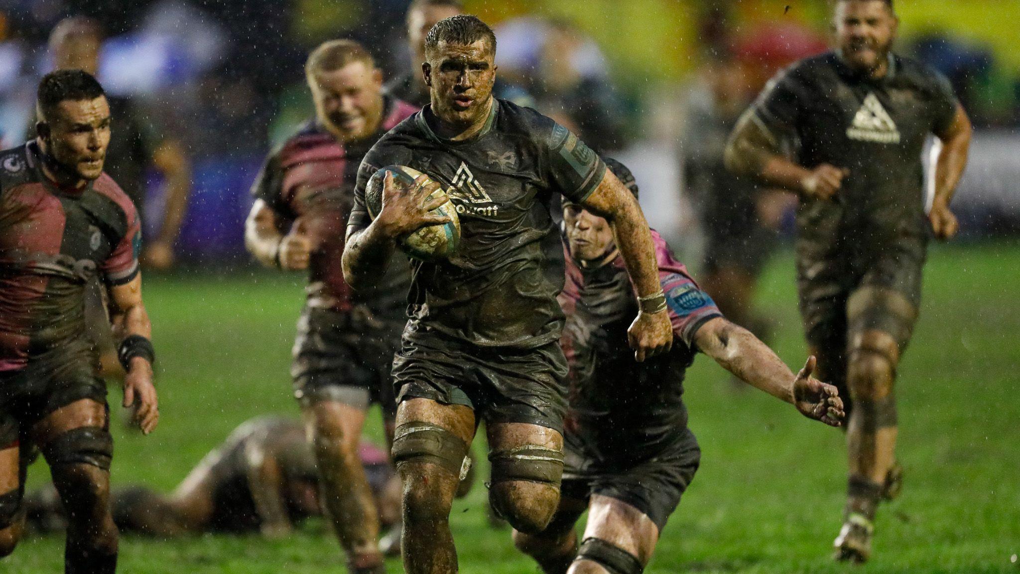 Morgan Morse running for Ospreys against Cardiff in muddy conditions