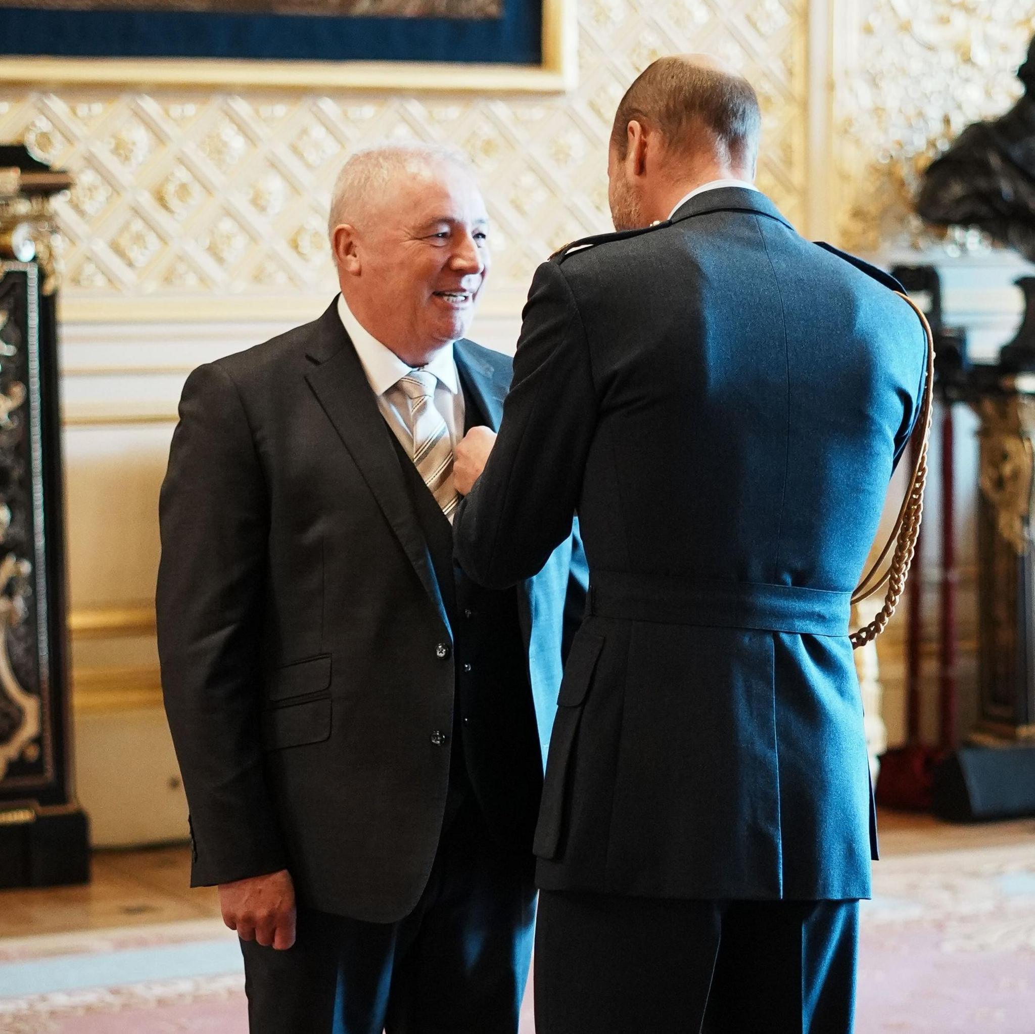 Ally McCoist receiving OBE from Prince William