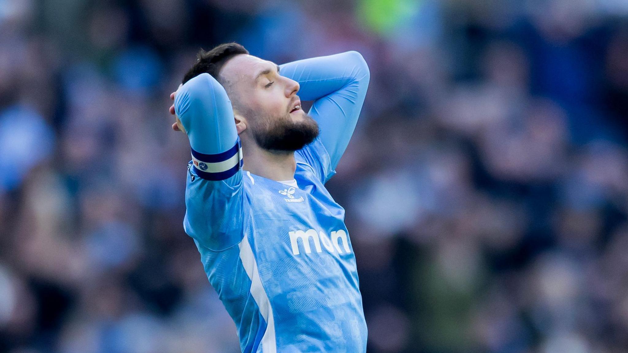 Coventry captain Matt Grimes has his eyes closed and his hands on his head as the Sky Blues can only draw with Oxford