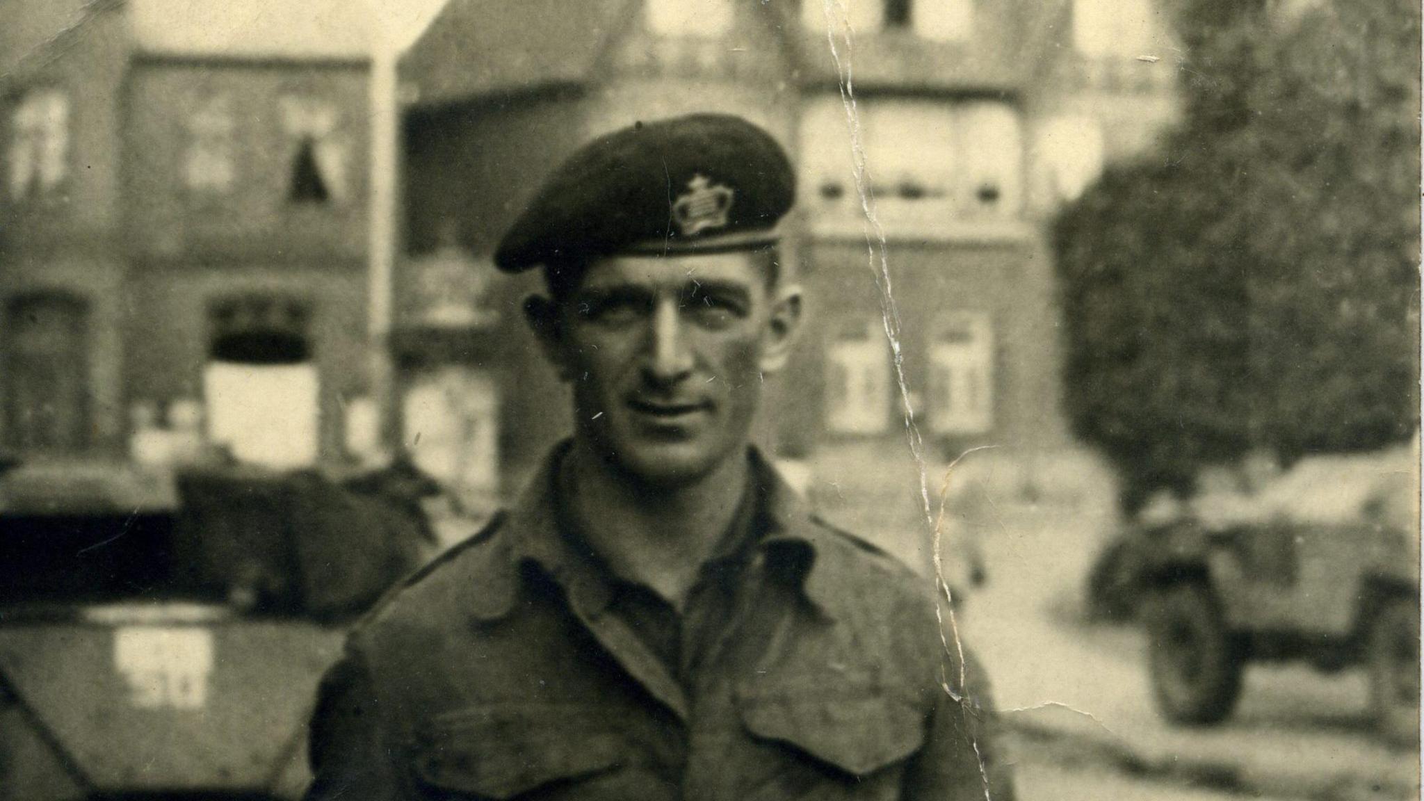 A black and white photo of a young soldier smiling