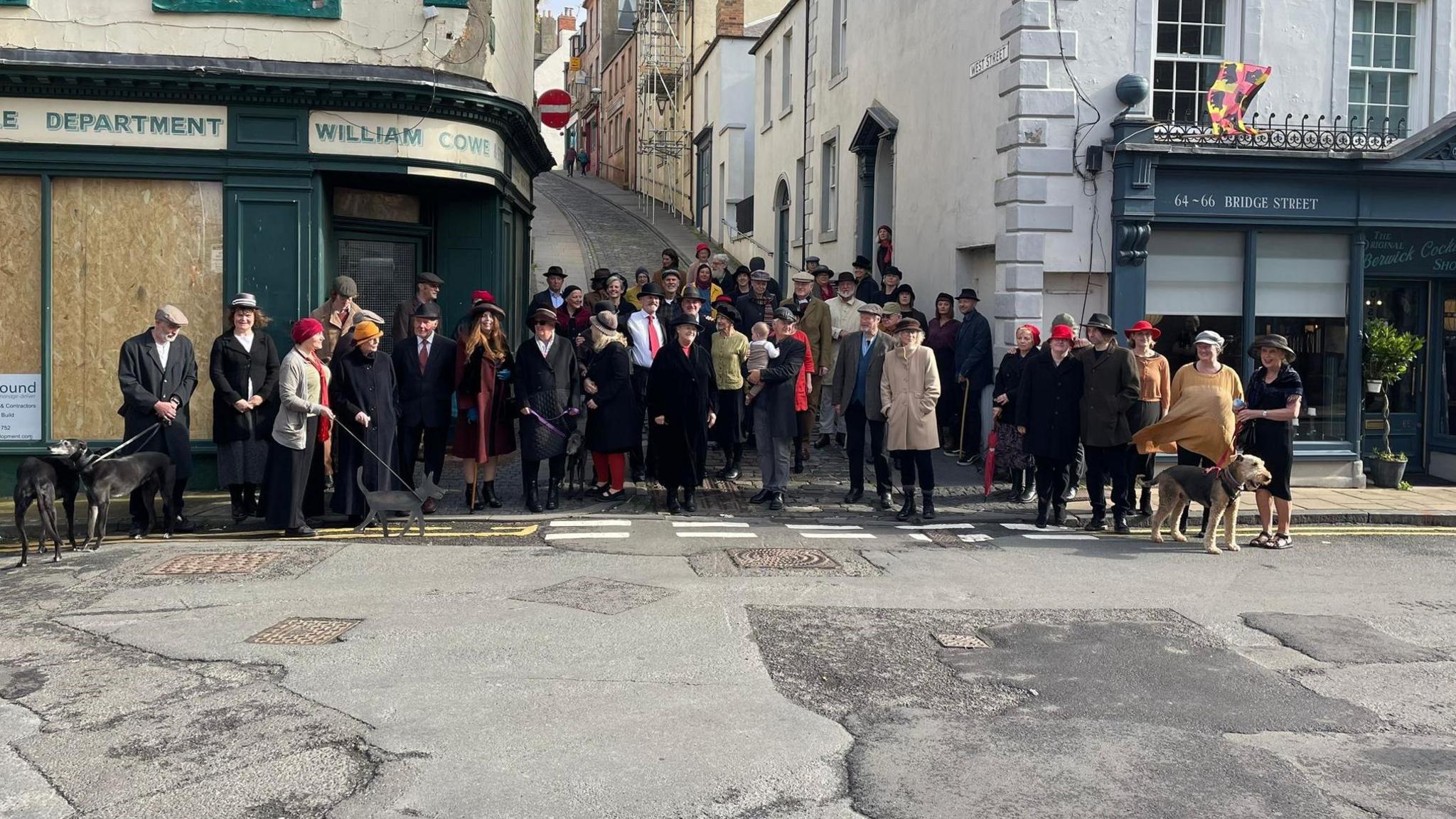 A picture of about 50 or 60 people all dressed in 1930s clothing at the base of Bridge Street in Berwick 