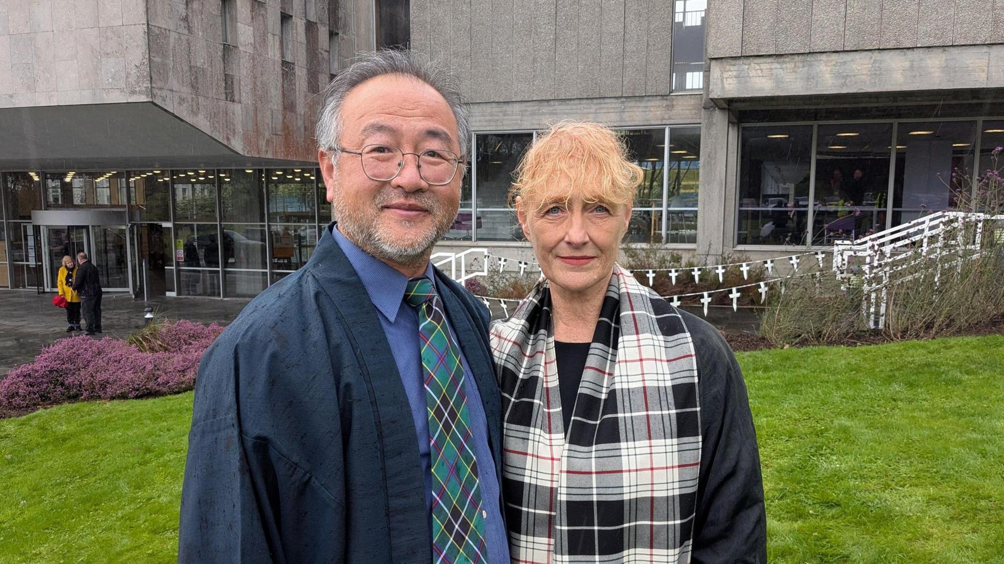 A woman and her husband stand in front of Cornwwall Council's headquarters in Truro. 