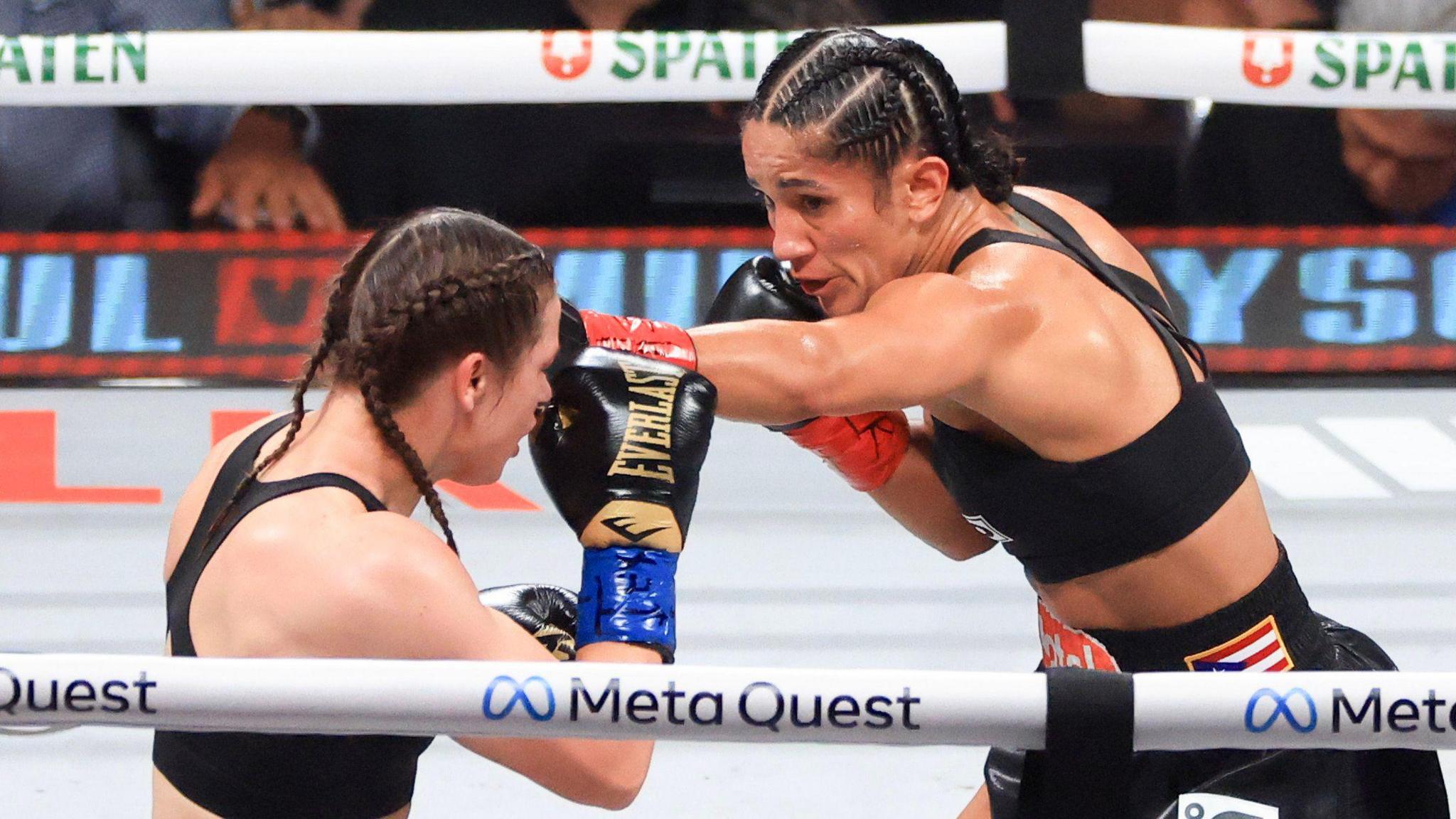 Amanda Serrano (right) punches Katie Taylor (left)