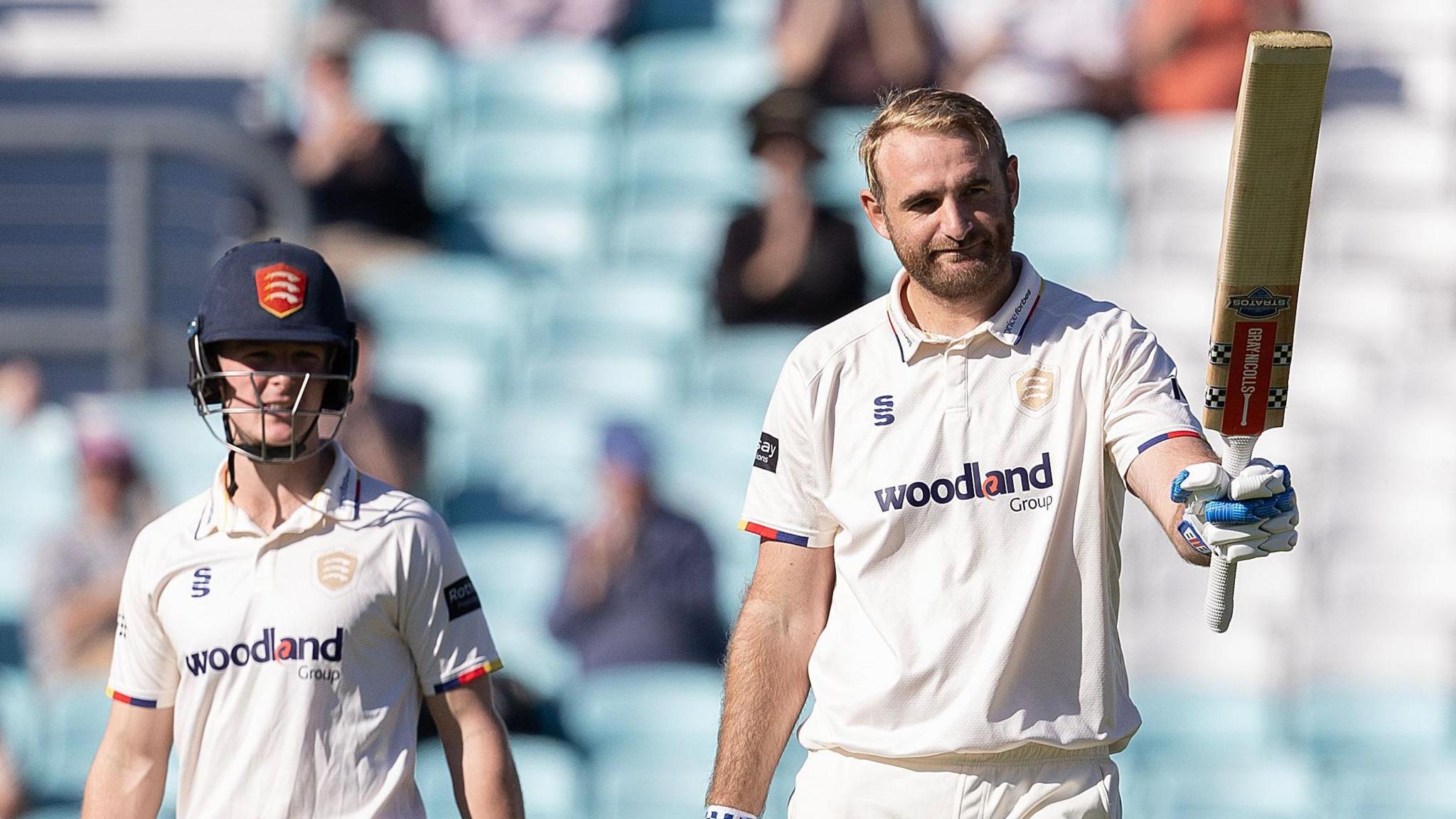 Paul Walter raises his bat after reaching three figures for Essex